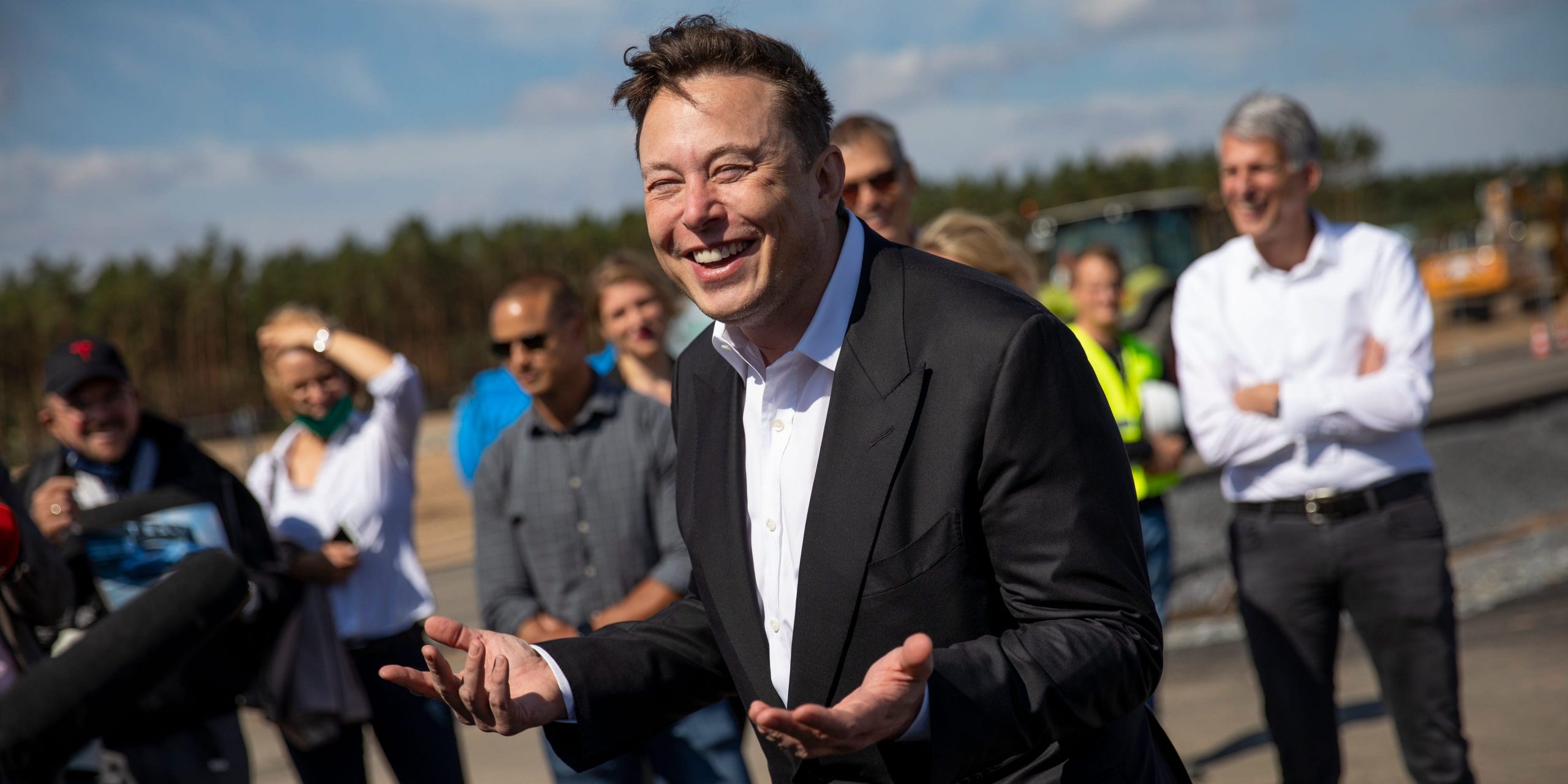 Tesla head Elon Musk talks to the press as he arrives to to have a look at the construction site of the new Tesla Gigafactory near Berlin