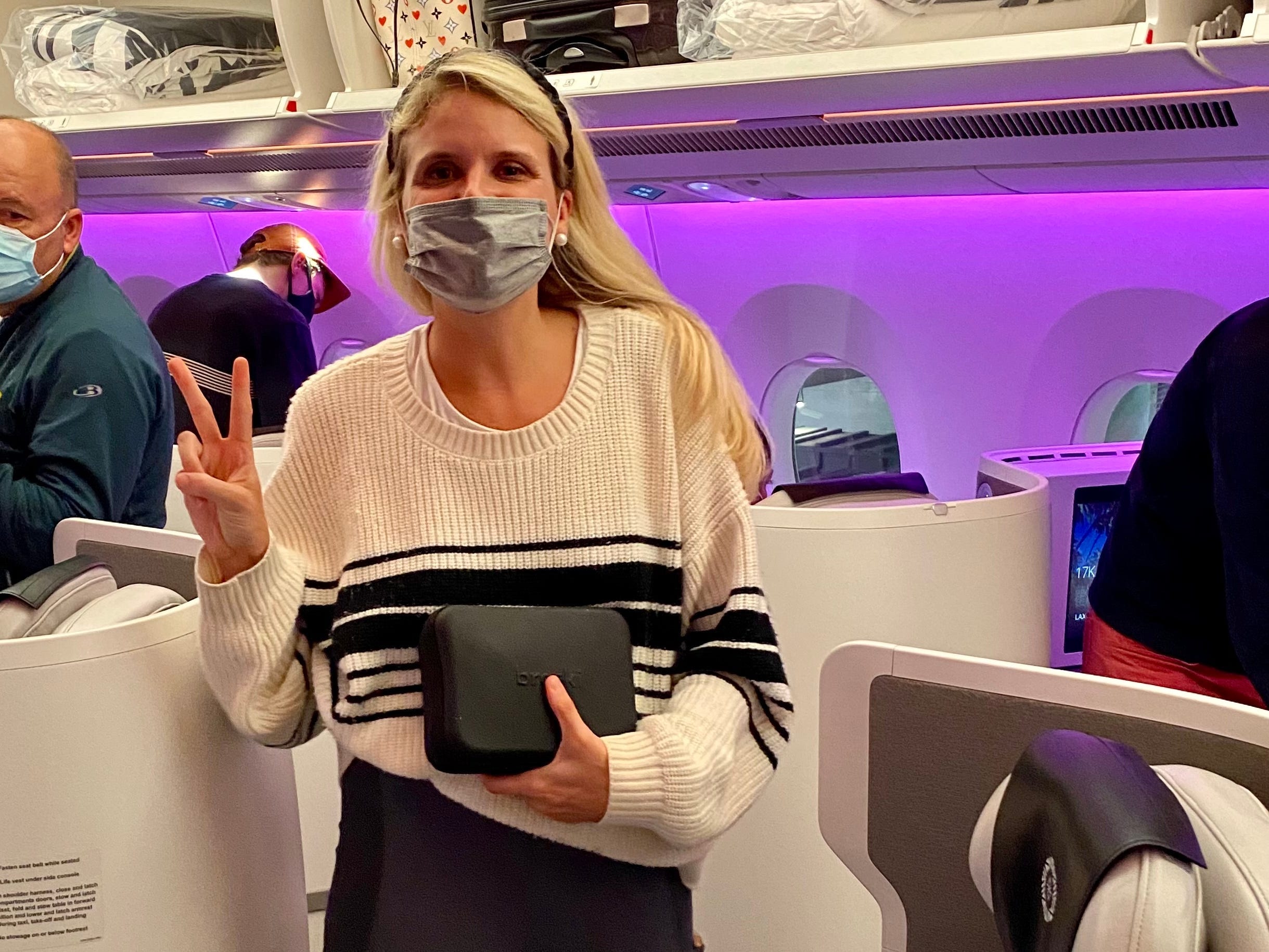 The writer wearing a mask in business class on a Fiji Airlines flight