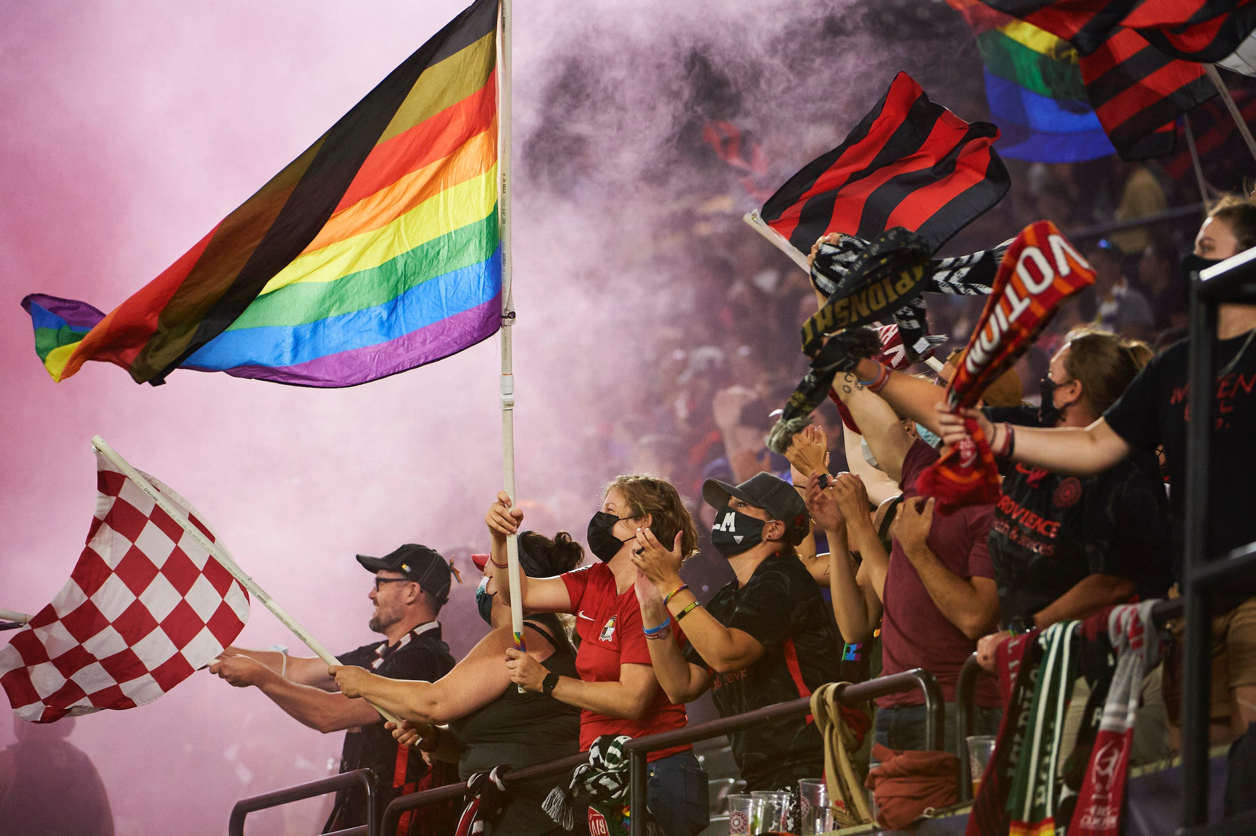Portland Thorns fans — known as the Rose City Riveters — regularly fly pride flags at NWSL games.