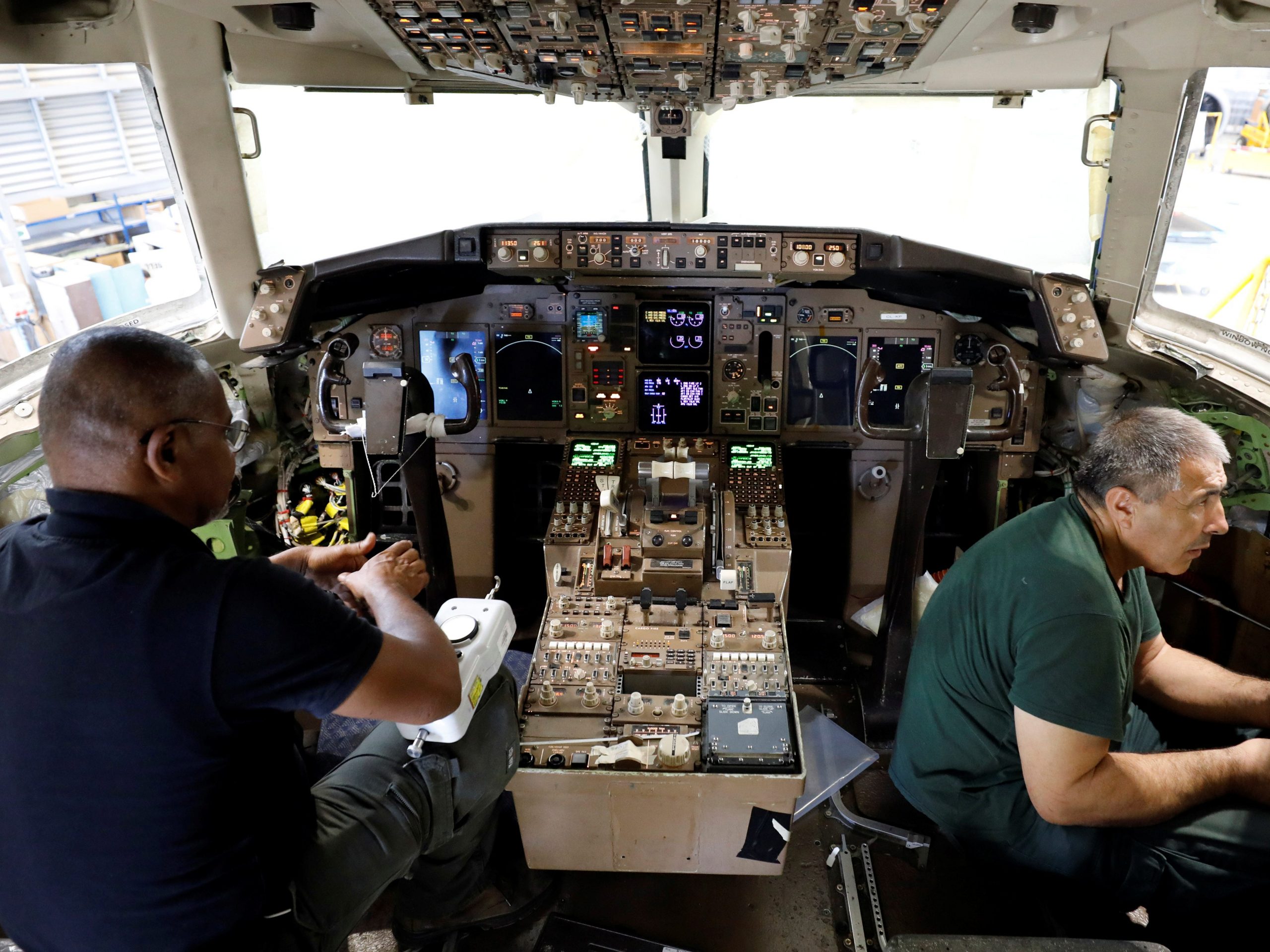 Labourers work inside the cockpit of a passenger plane as they convert it into a cargo plane at Israel Aerospace Industries site in Ben Gurion International Airport, Lod, Israel July 3, 2019. REUTERS/Amir Cohen