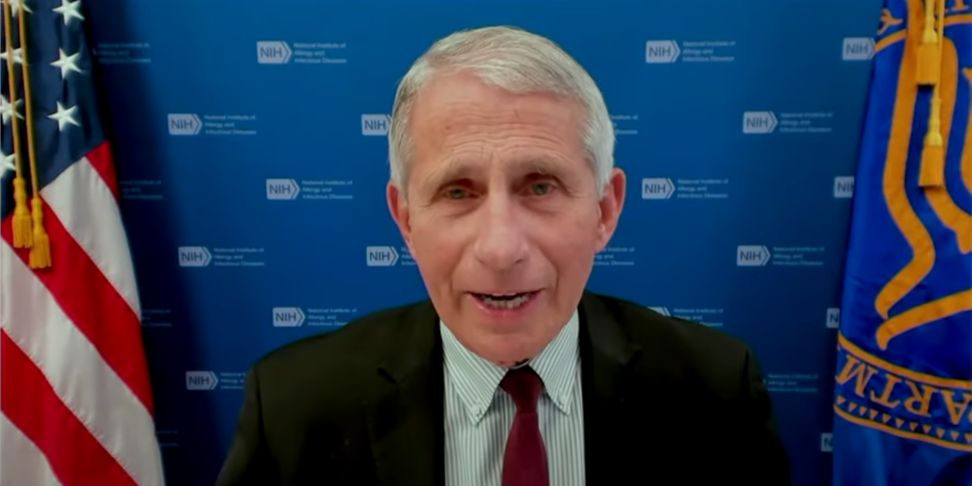 Dr Antony Fauci speaking at a press briefing on June 22. He is sitting in front of two flags and a background that has the NIH logo repeating