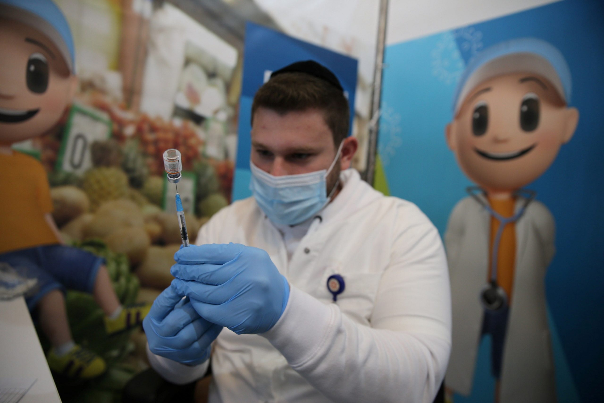 A healthcare worker prepares a dose of the COVID-19 vaccine