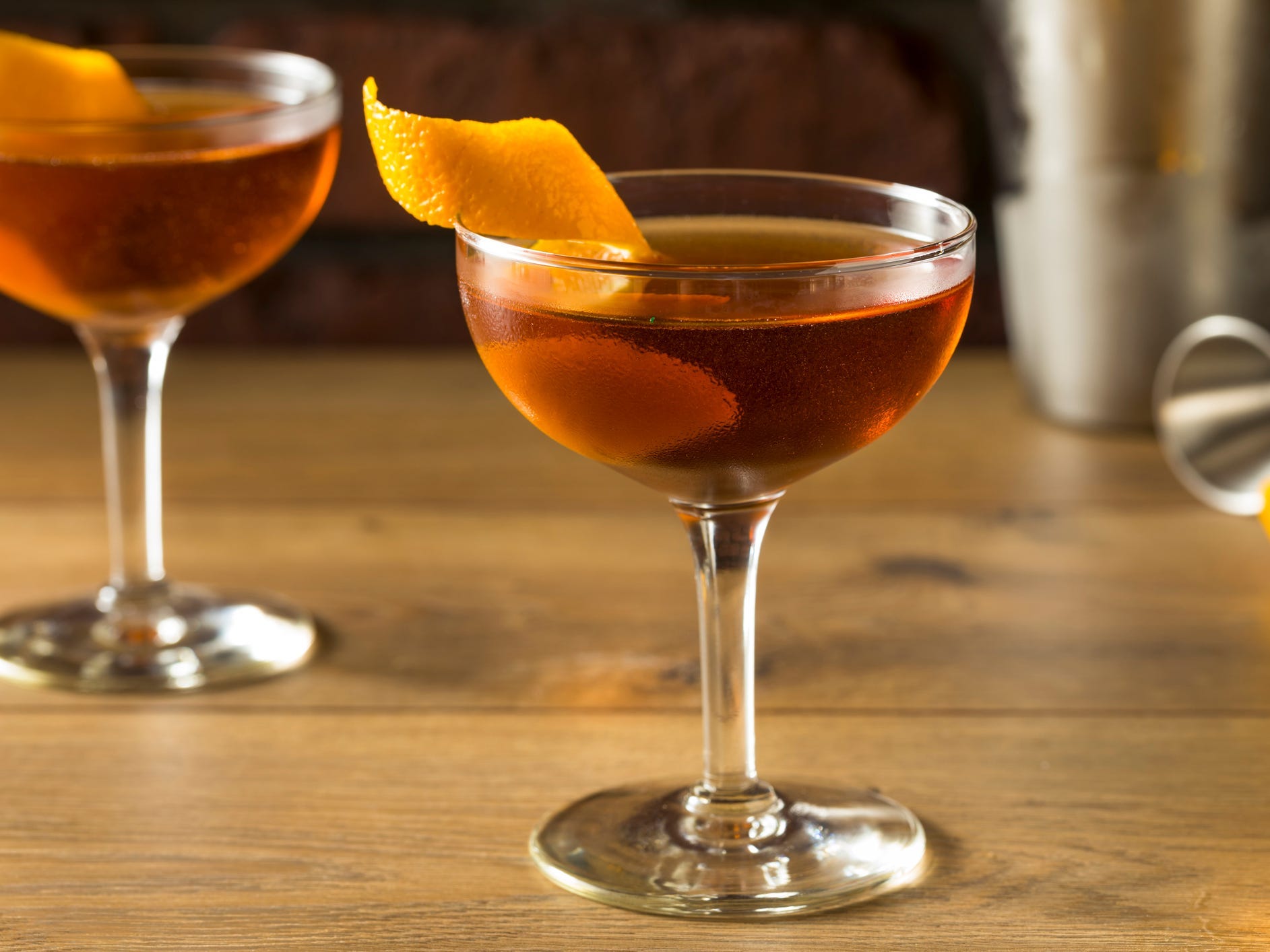 Two glasses of Martinez gin cocktail with orange twists.