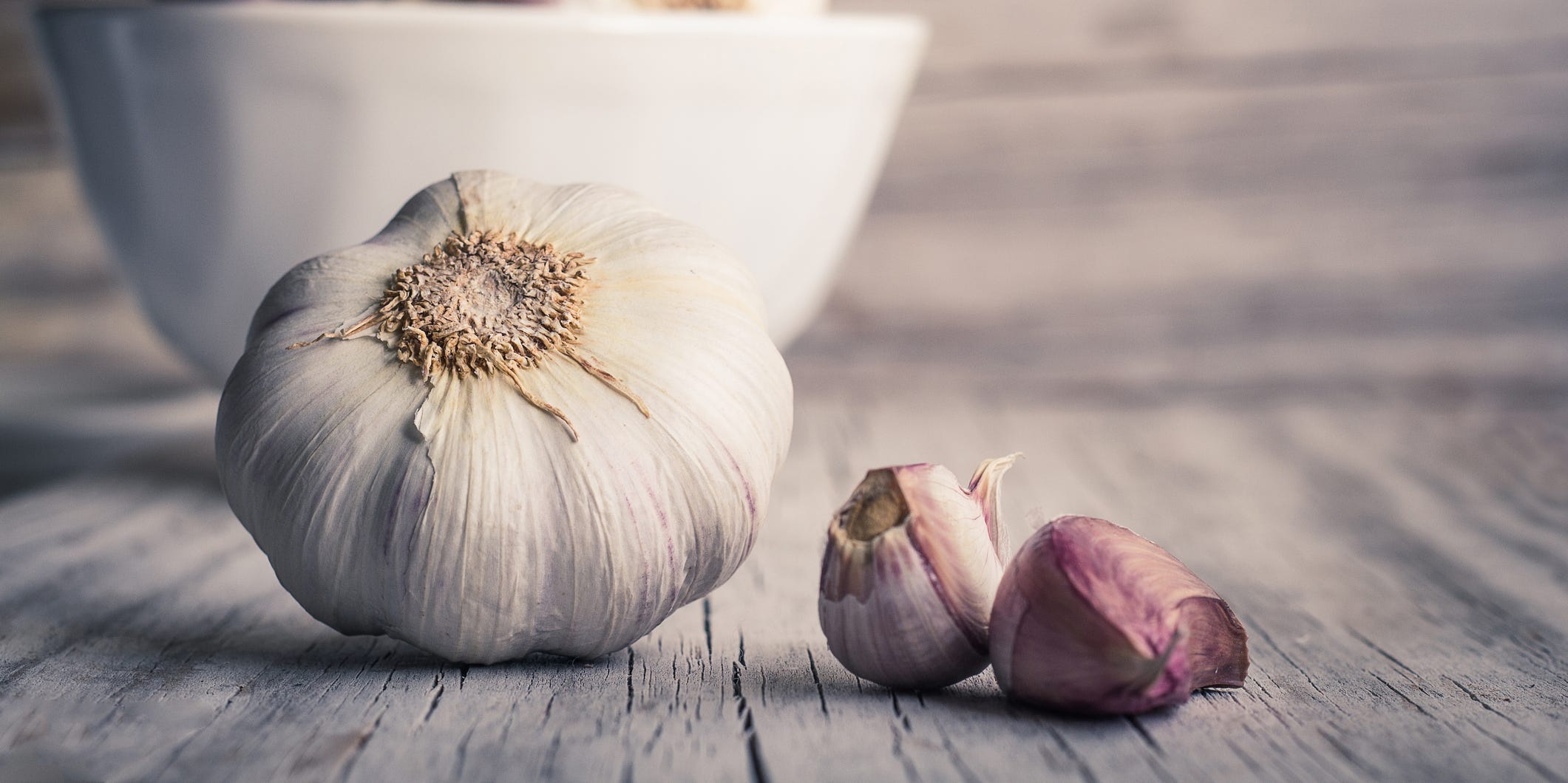 Close-up of a garlic bulb and some cloves.