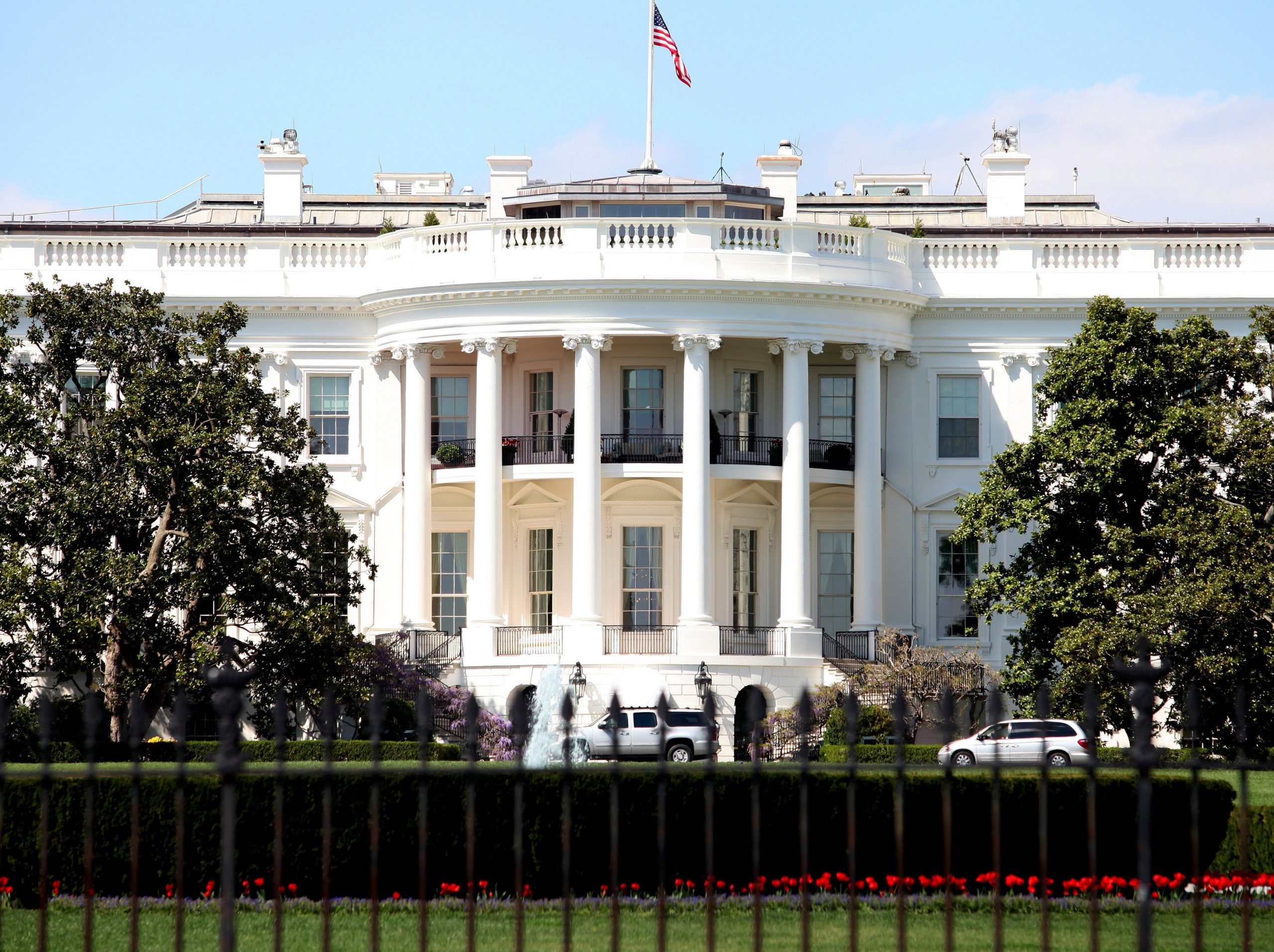 A picture of The White House, with a flag flying above it.