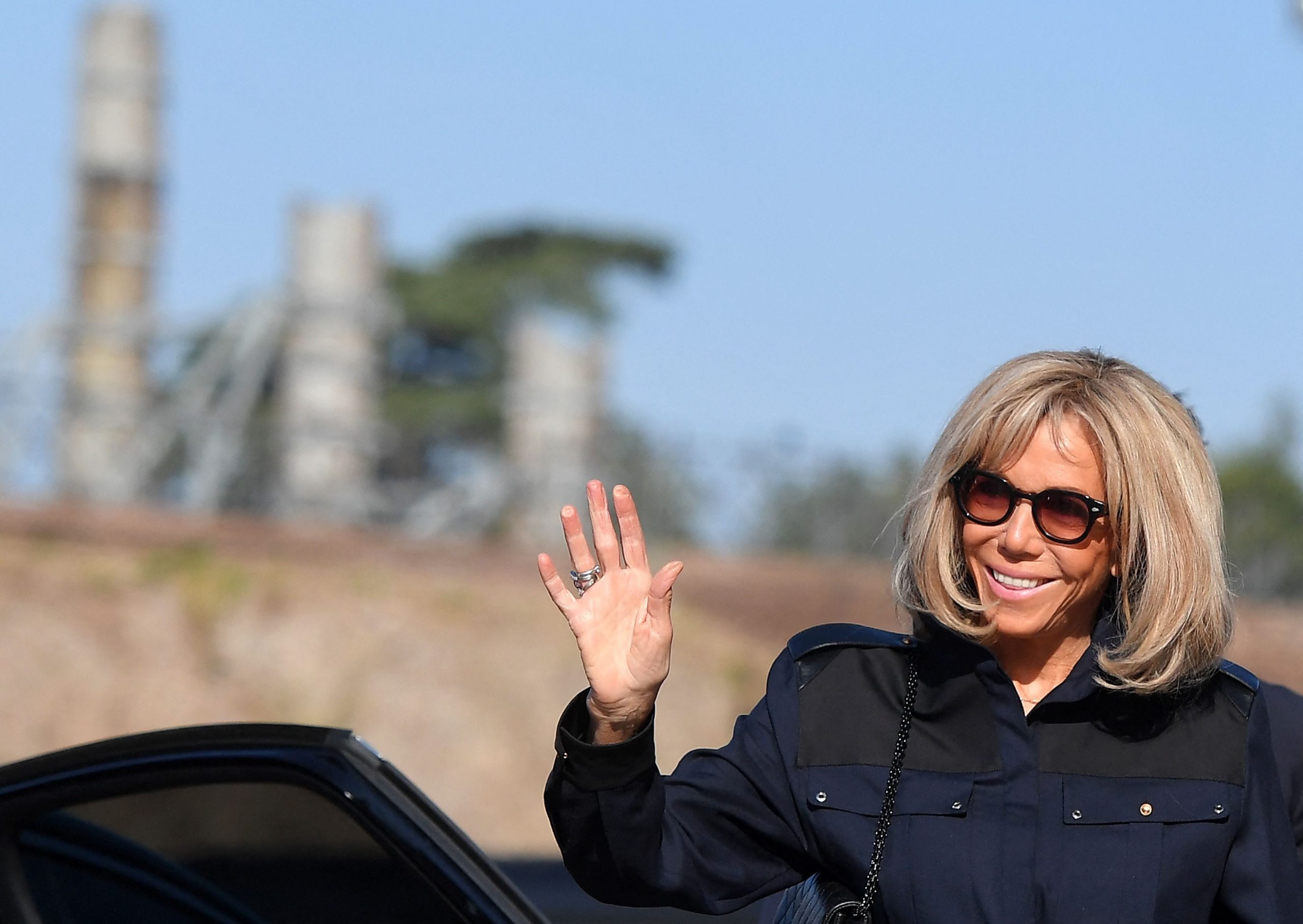 Brigitte Macron waves as she exits a car on a private visit to Rome.