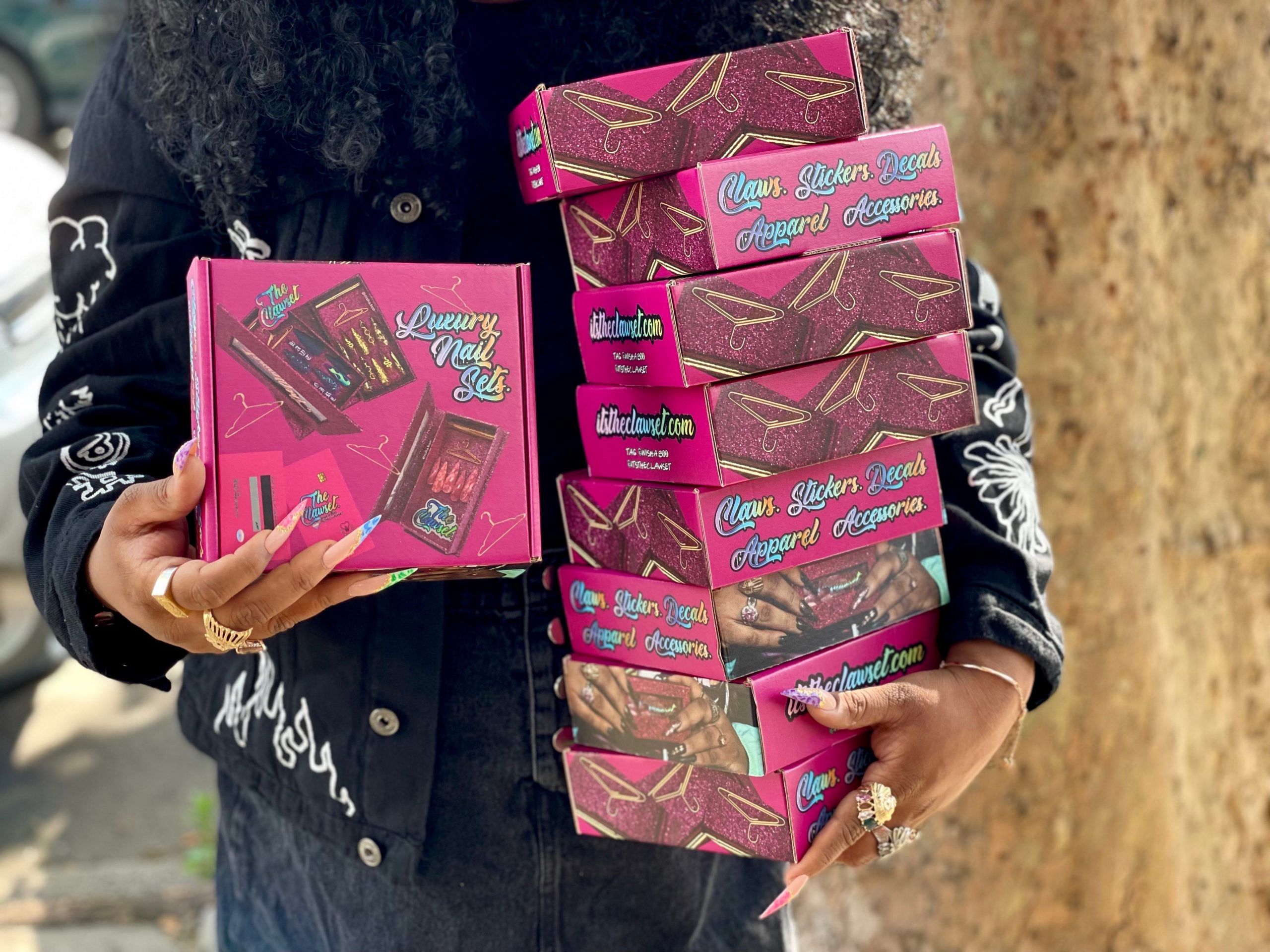 A woman holds pink boxes