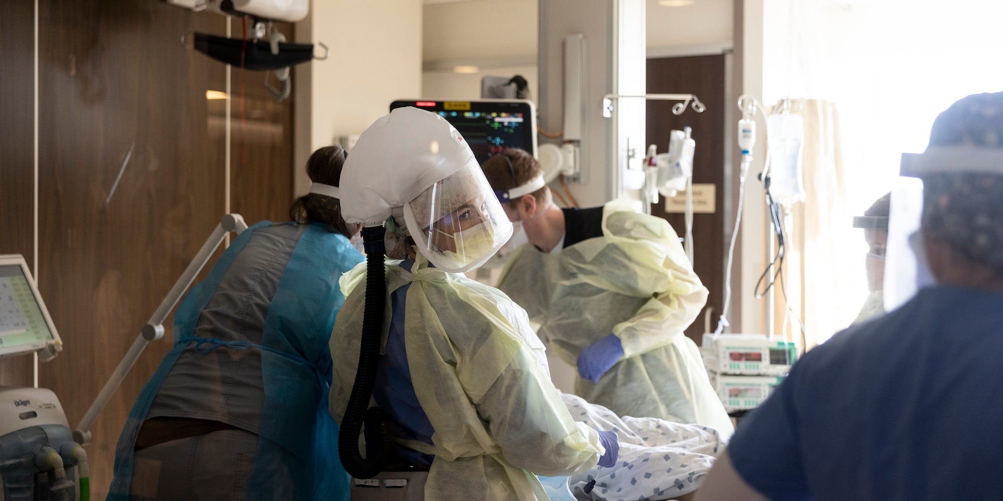 A team of nurses and physicians transfers a patient with COVID-19 into ICU room from the emergency room at CentraCare St. Cloud Hospital in St. Cloud, Minn., on Tuesday, Nov. 23, 2021.