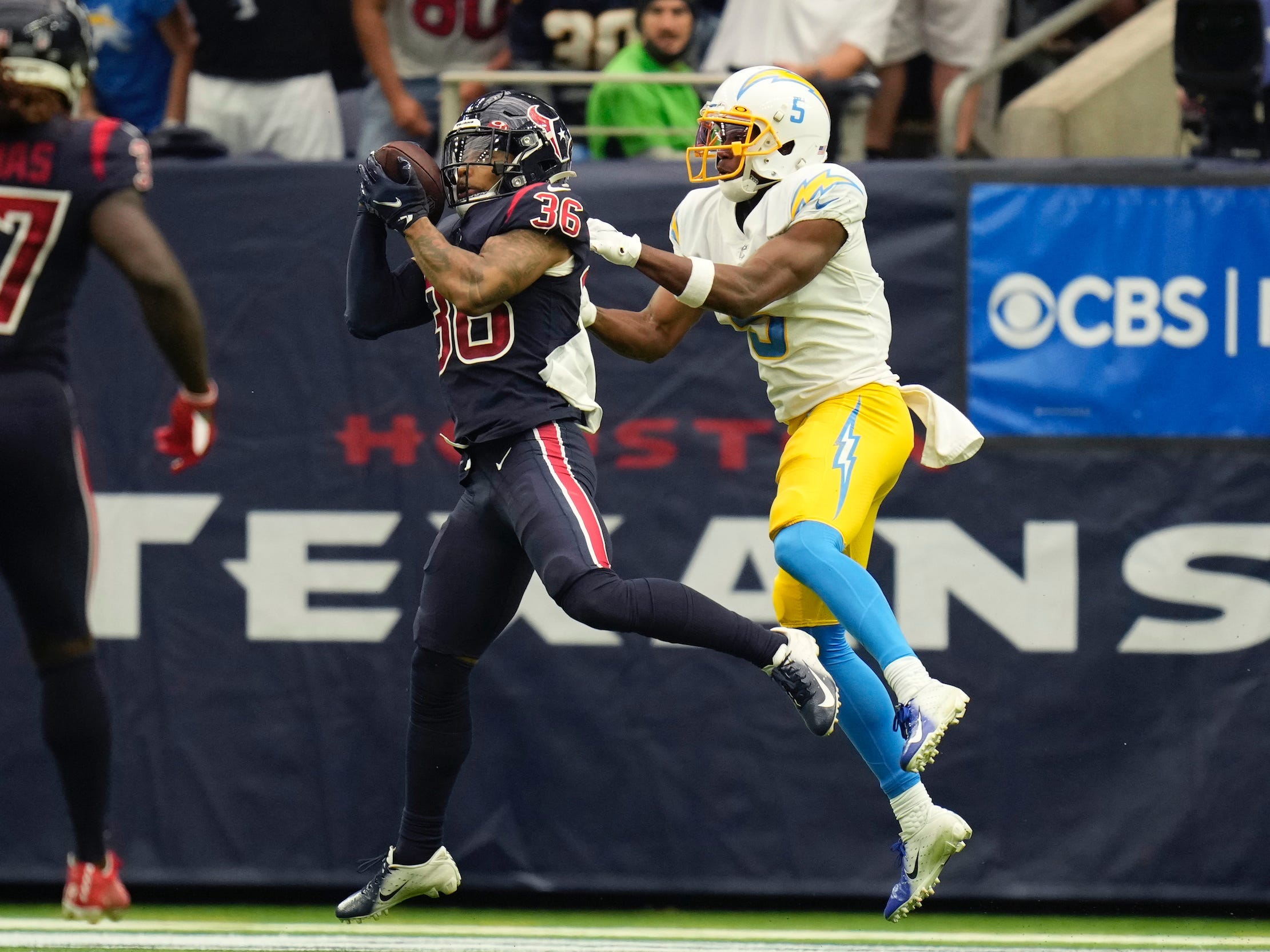 Jonathan Owens (left) pulls in his first career NFL interception.
