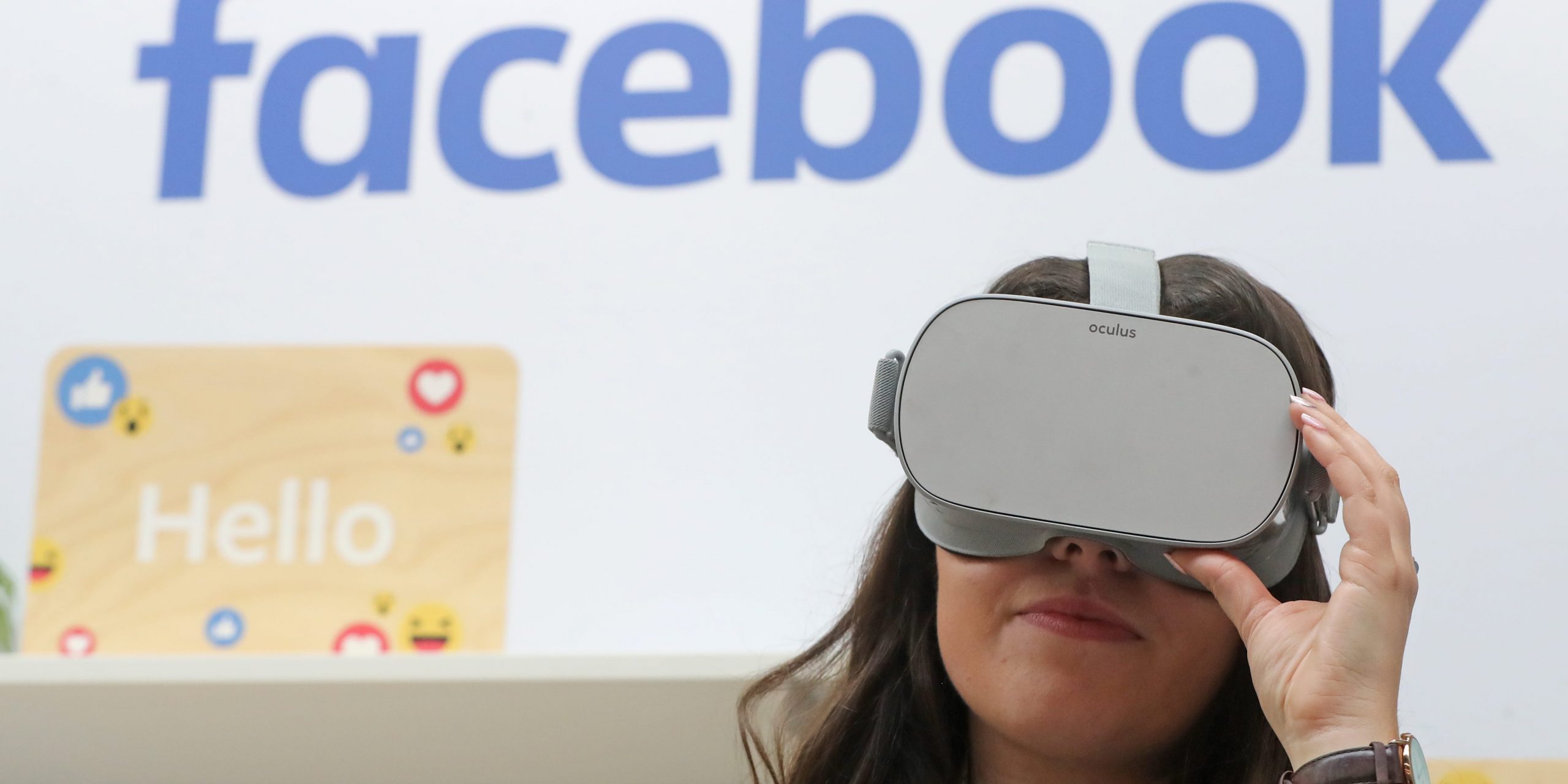 A woman uses an Oculus virtual reality headset at the Facebook stand during the Dublin Tech Summit.