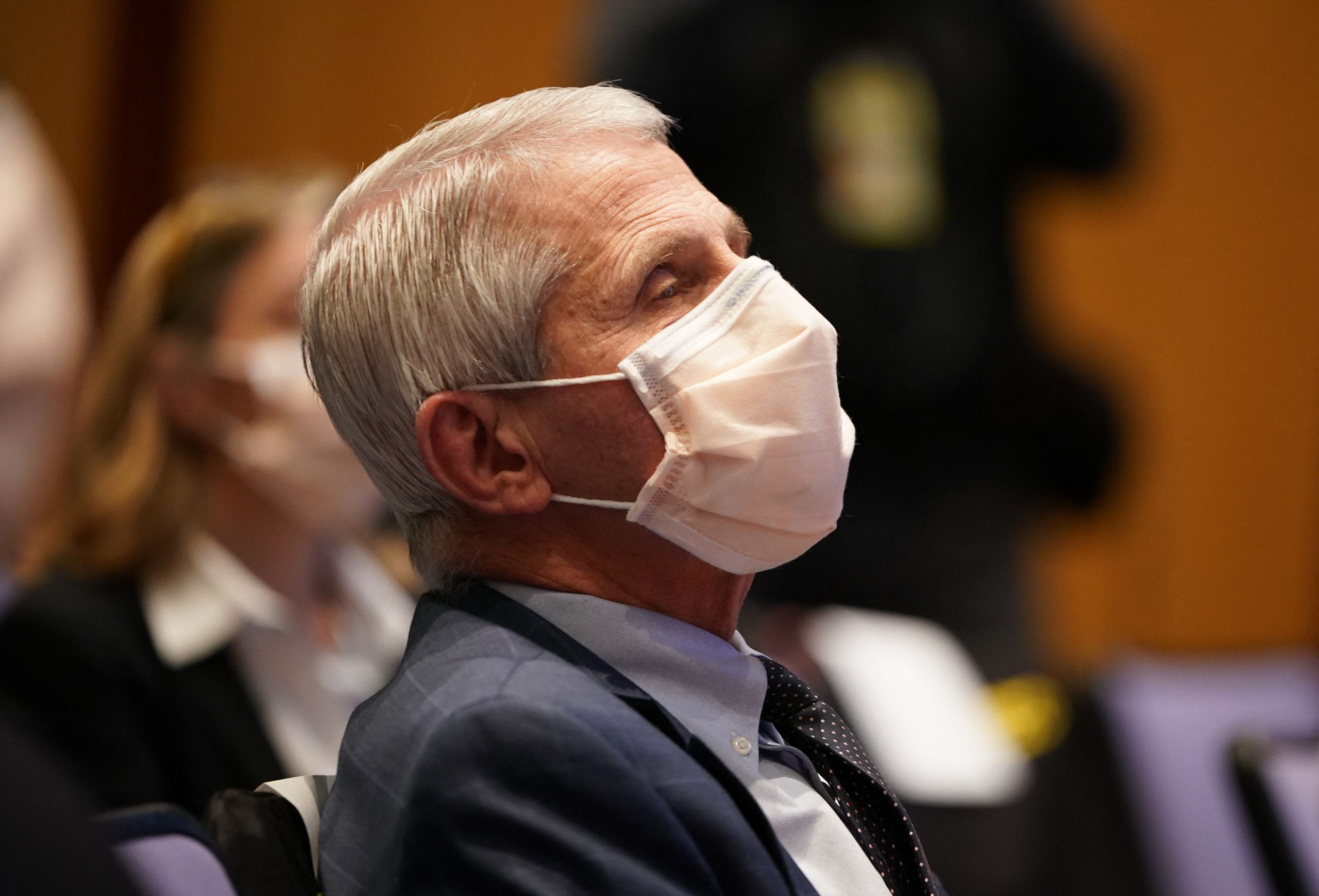 Dr. Anthony Fauci listens to President Joe Biden speak on the US response to the pandemic.