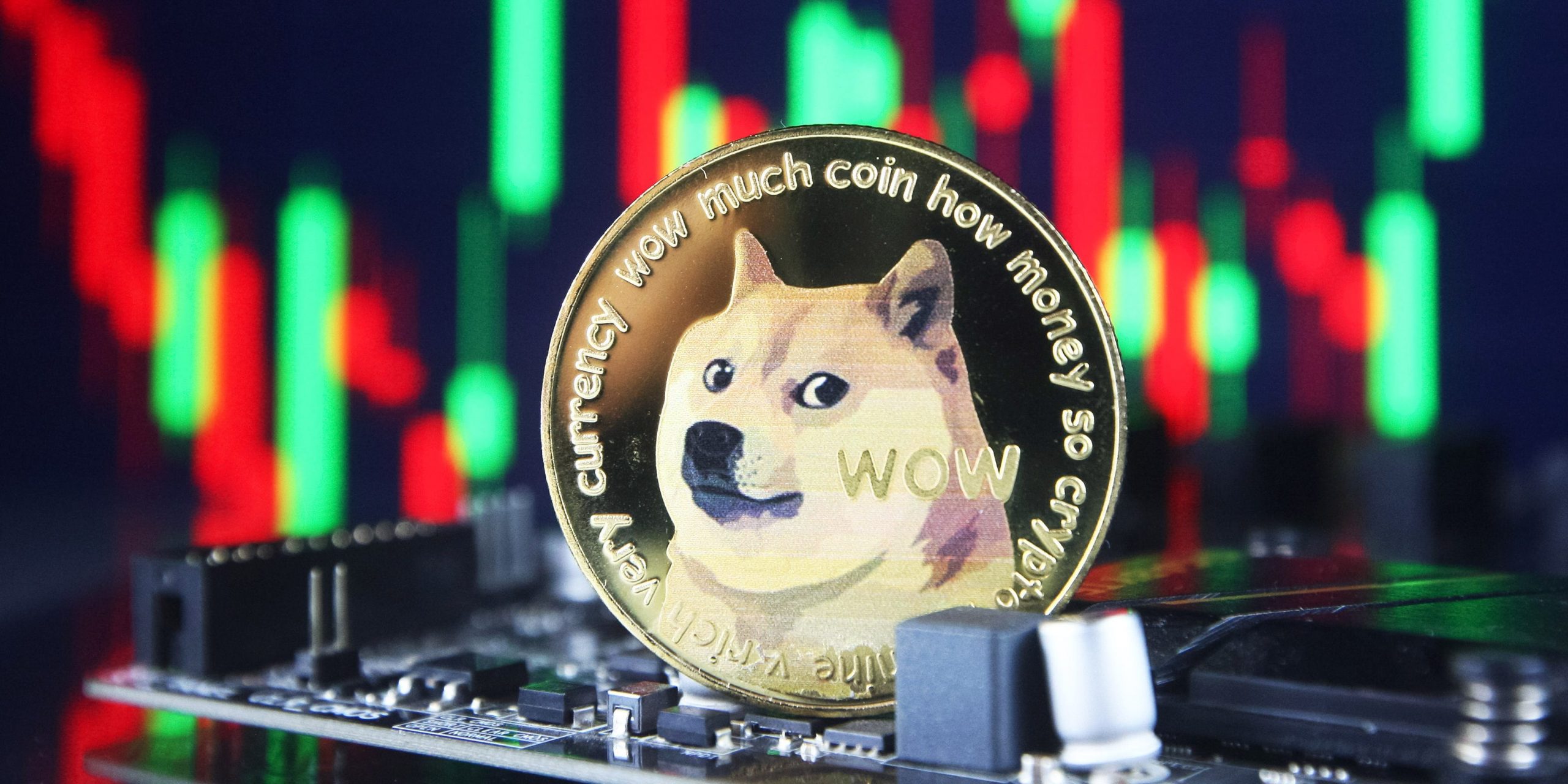 Dogecoin cryptocurrency coin and a graph are pictured in Kyiv on 08 July, 2021.