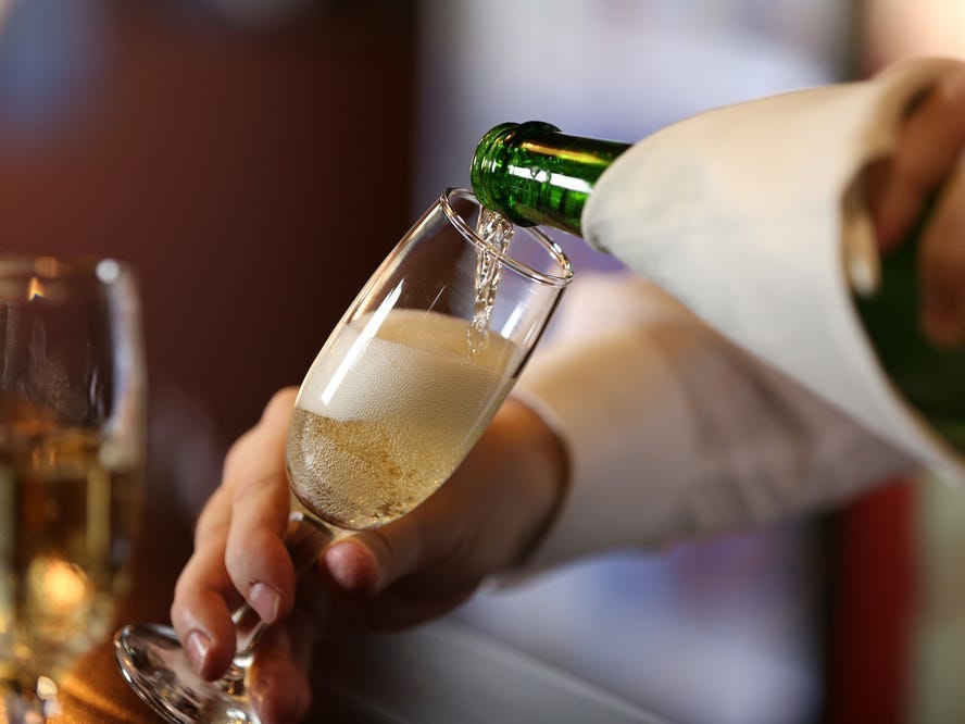 Close-up of someone pouring a glass of Champagne.