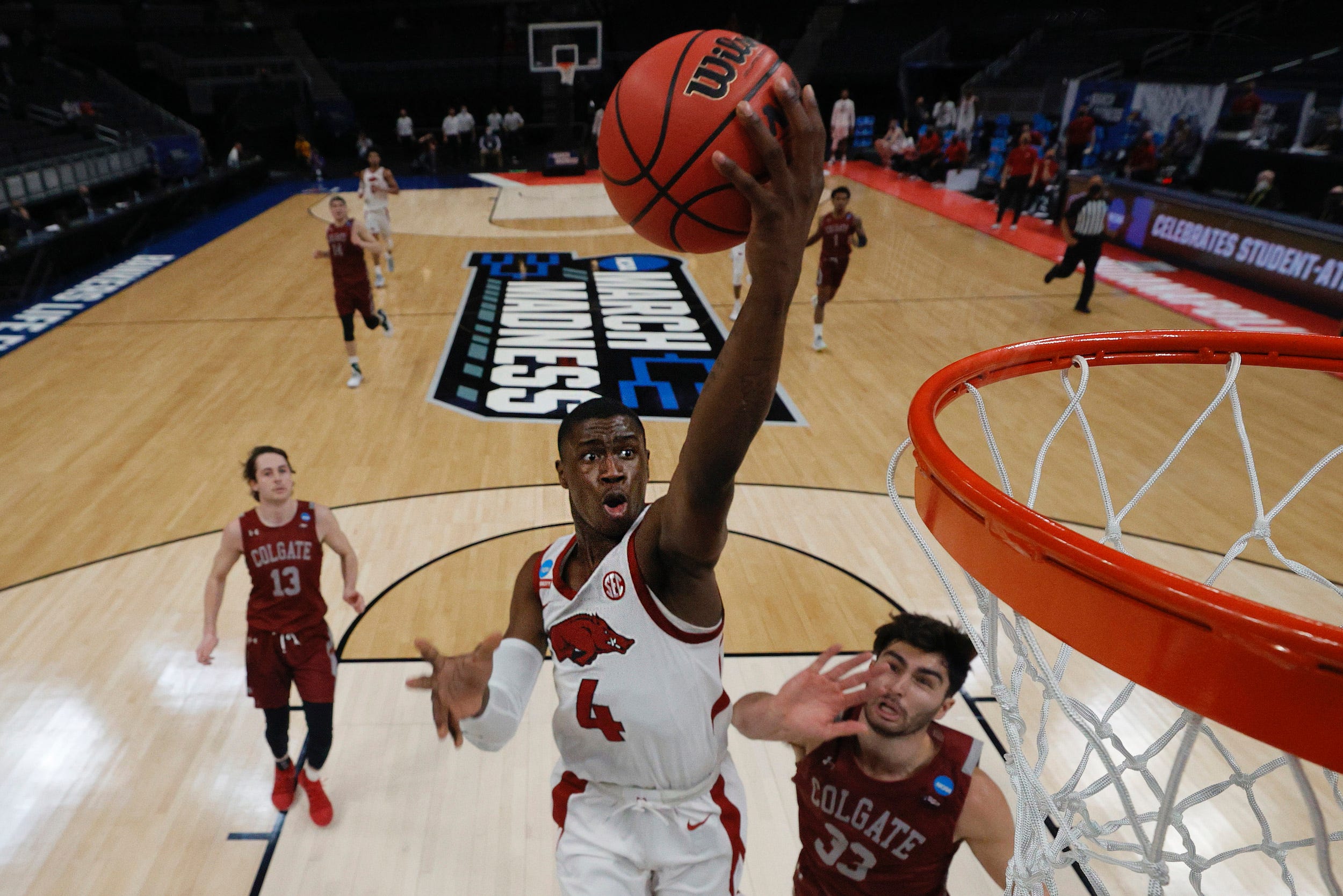 Arkansas Razorbacks' Davonte Davis goes to the basket as Colgate Raiders' Oliver Lynch-Daniels defends during a first-round 2021 NCAA Men's Basketball Tournament game at Bankers Life Fieldhouse.