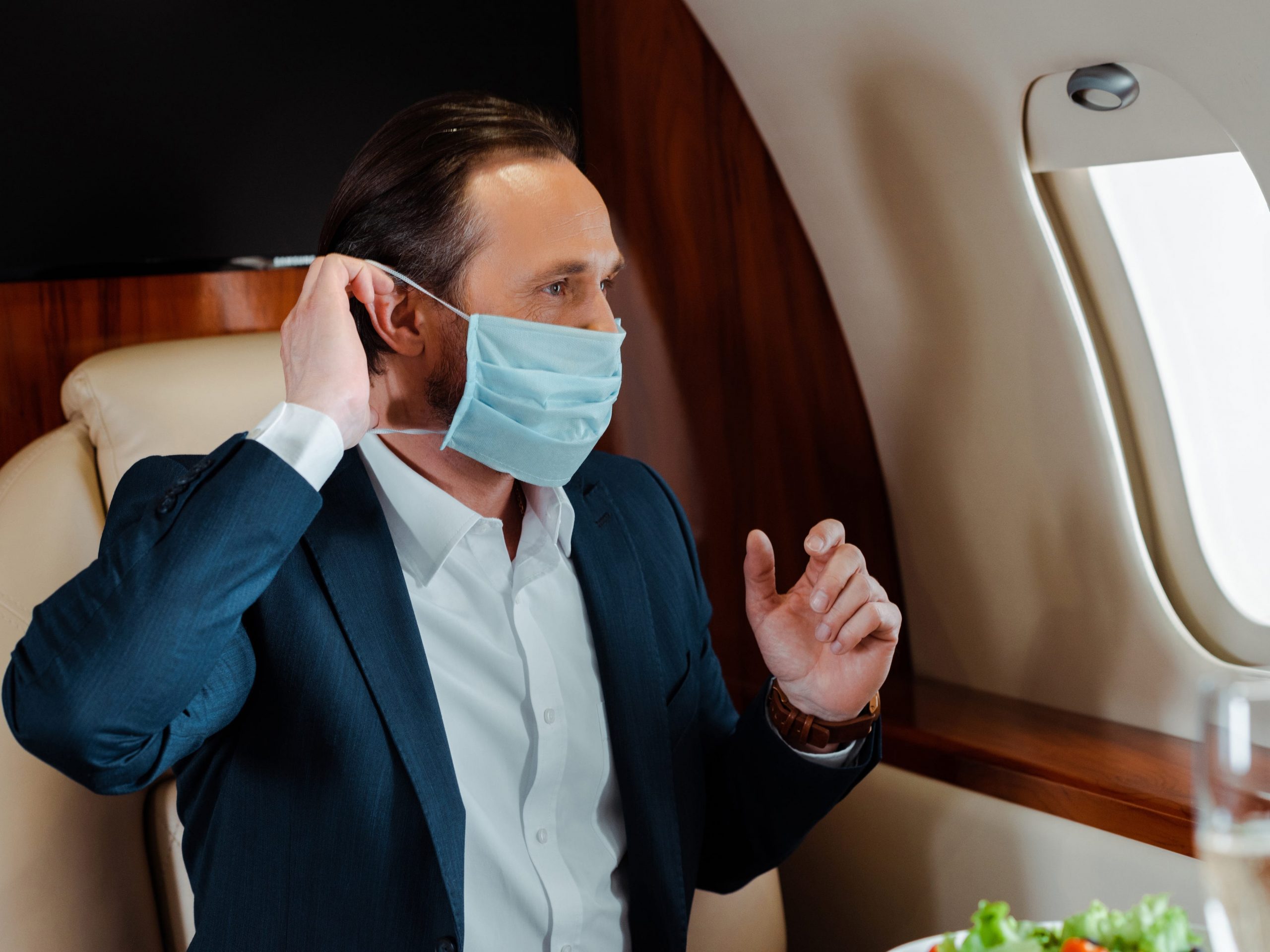 Private jet flyer wearing a mask