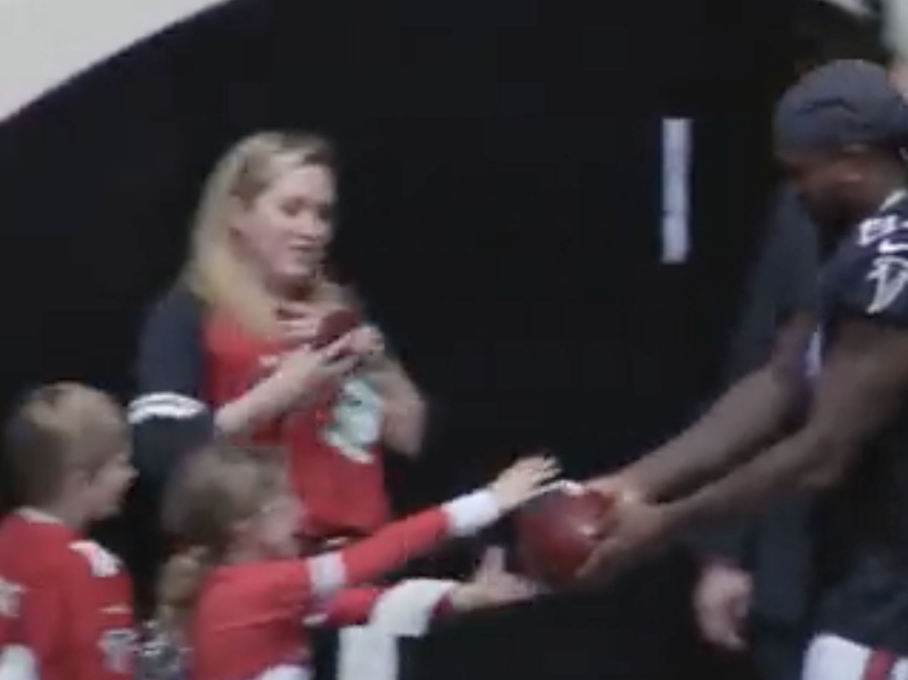 Cordarrelle Patterson gives a ball to a young fan.