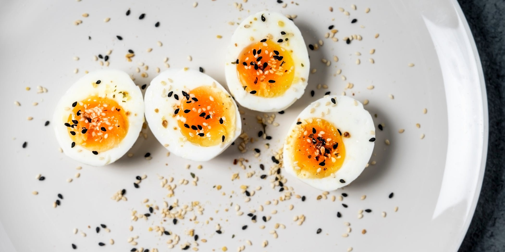 Halved hard boiled eggs sprinkled with seeds.