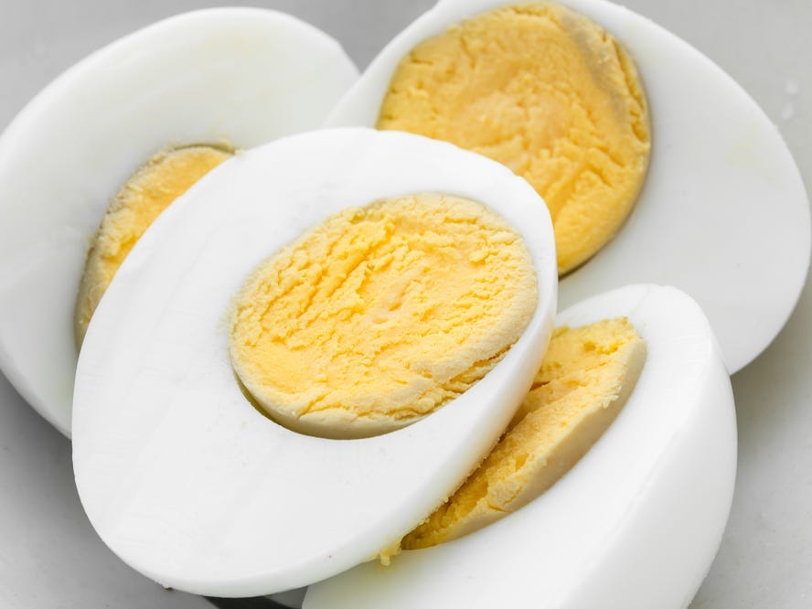 Close up of a pile of halved boiled eggs.