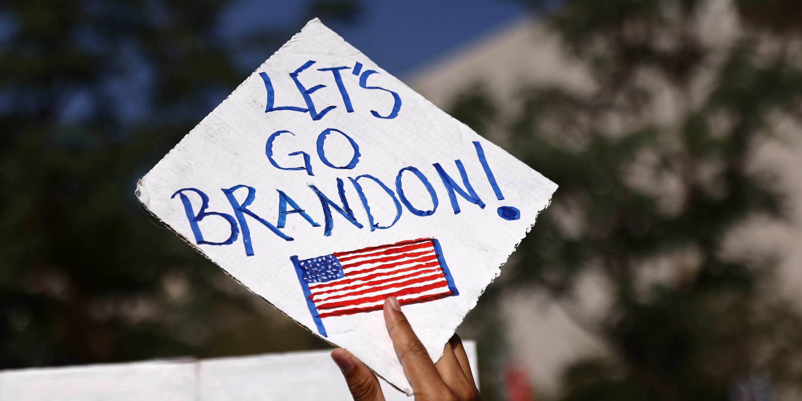 A protestor holds a 'Let's Go Brandon!' sign at a rally in Los Angeles in November 2021.