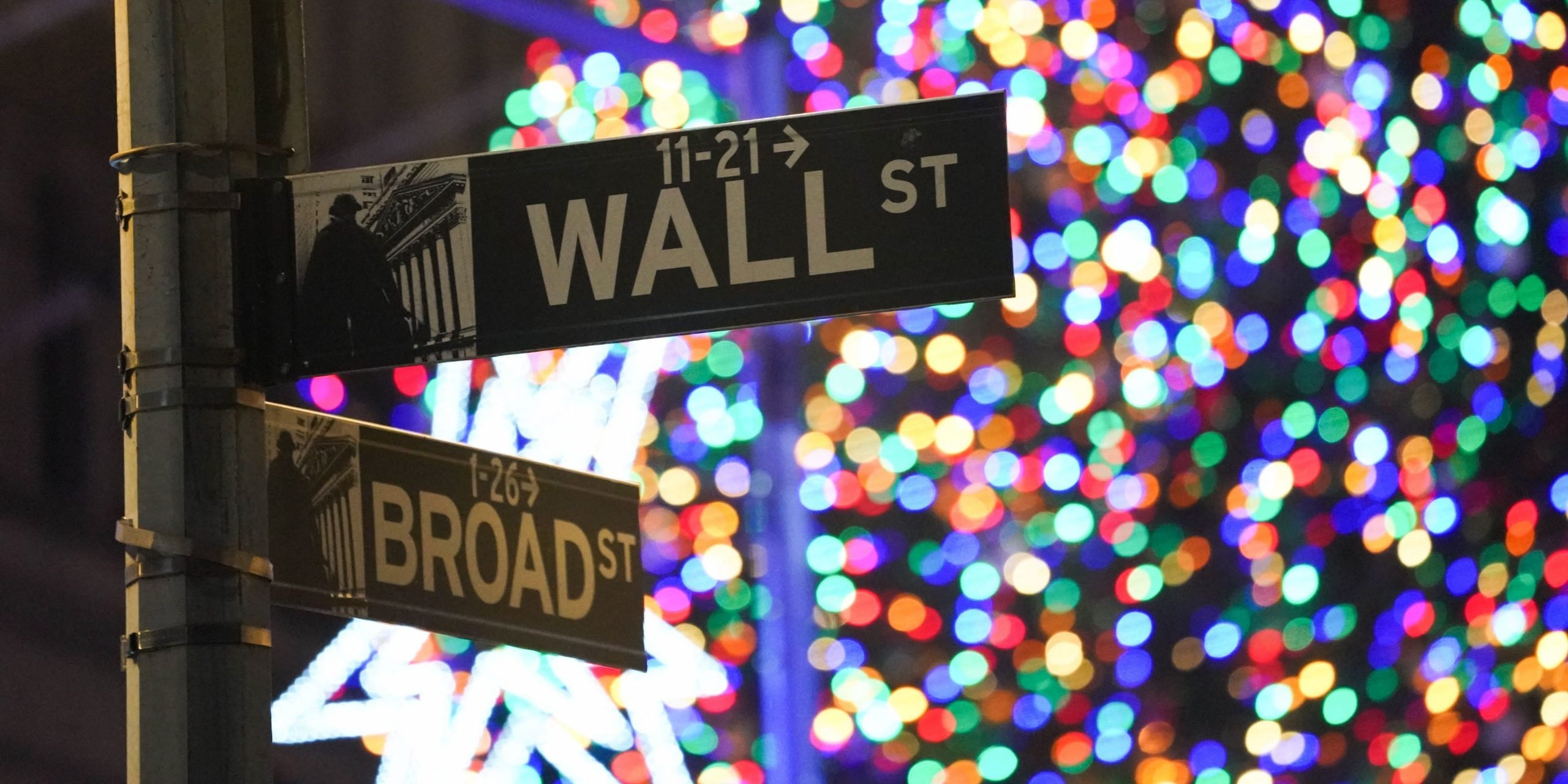 The corner street signs of Wall Street and Broad Street are seen during the 98th Annual Christmas Tree lighting ceremony at the New York Stock Exchange on December 1, 2021 in New York.