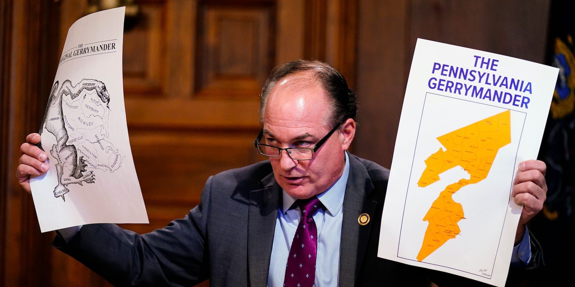 House Majority Leader Kerry Benninghoff, R-Centre holds up maps during a meeting of the Pennsylvania Legislative Reapportionment Commission at the Capitol in Harrisburg, Pa., Thursday, Dec. 16, 2021