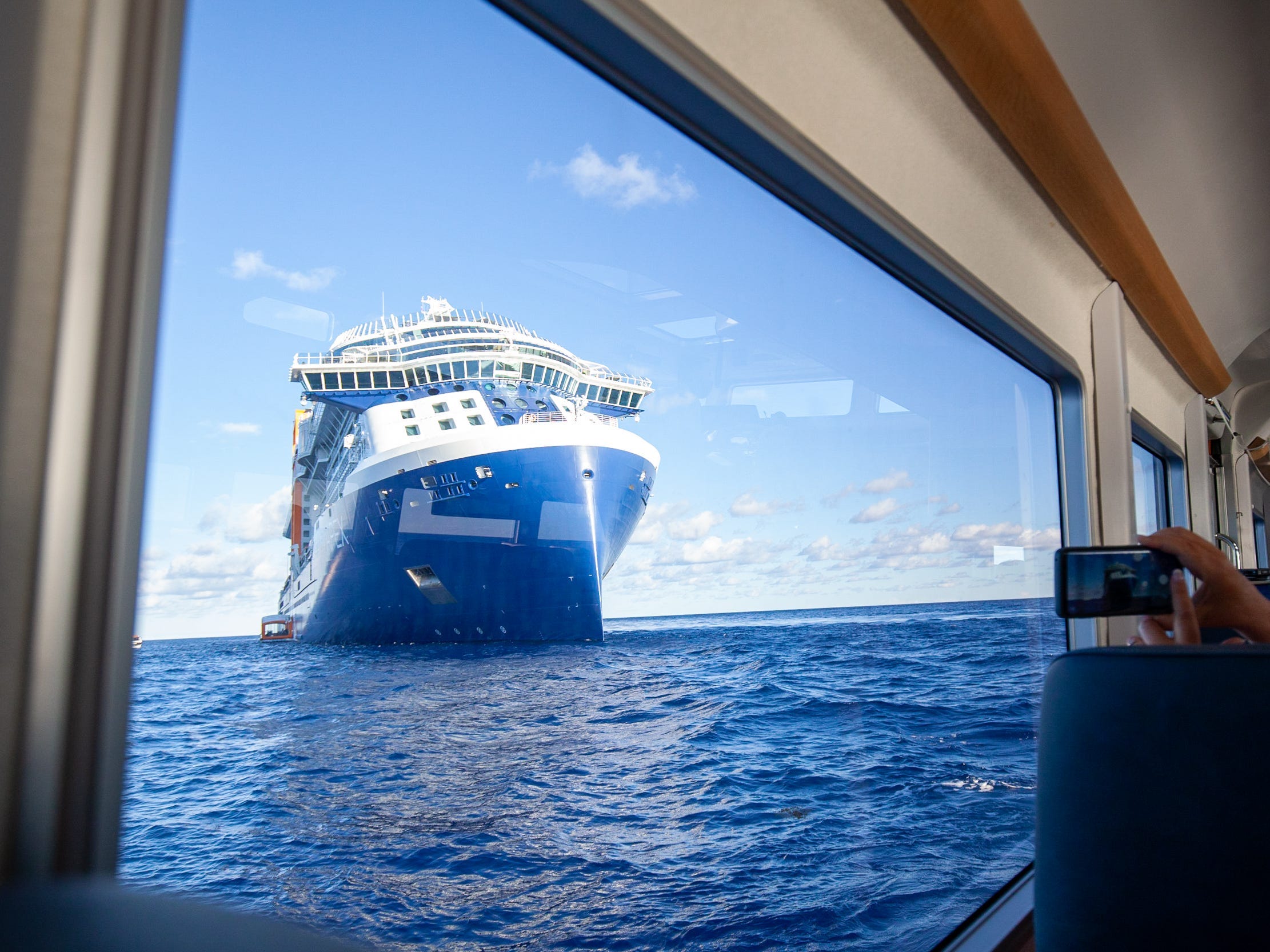 the Celebrity Apex cruise ship at sea as photographed through the window of a tender