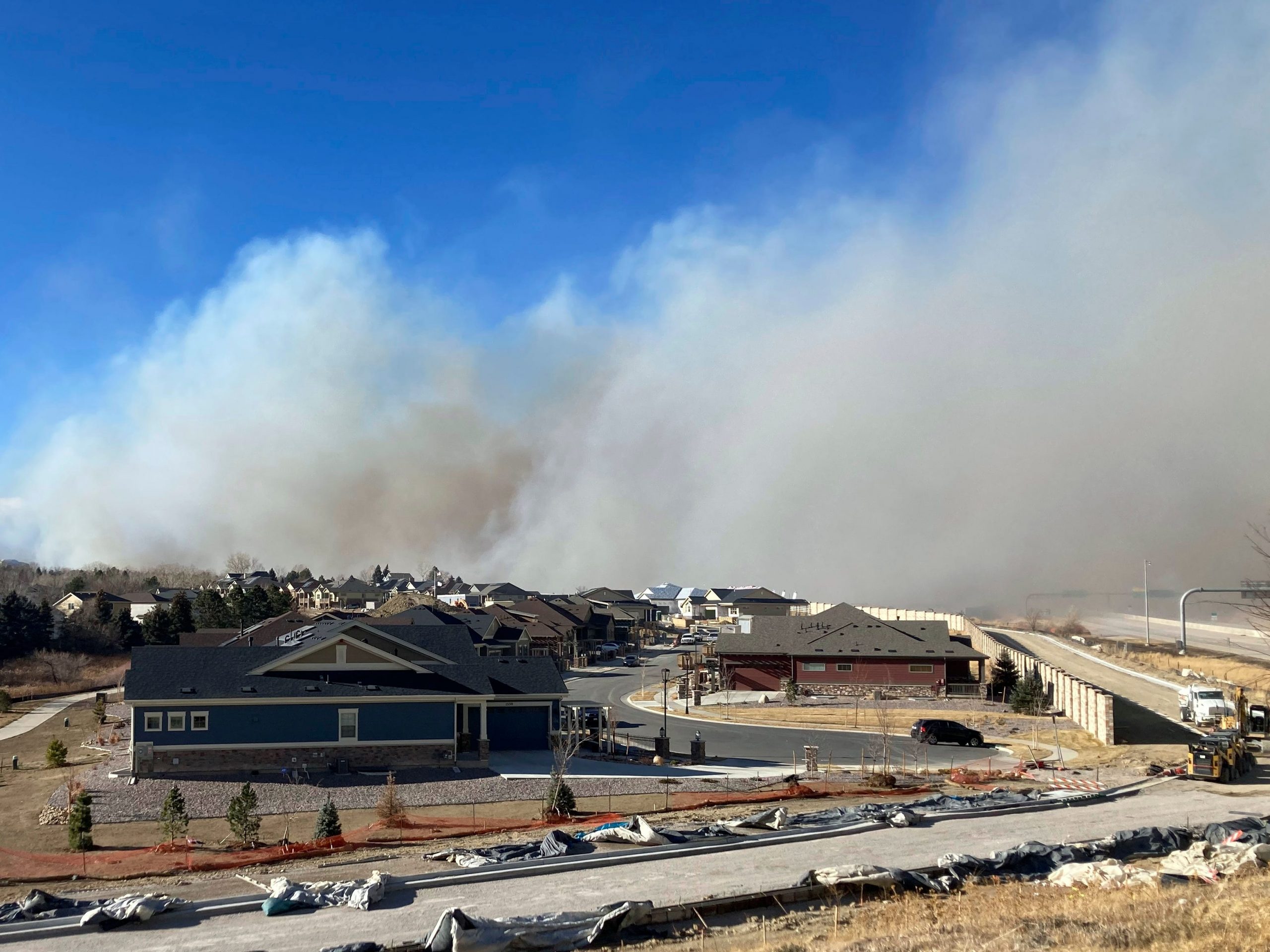 Smoke from a wildfire rises on Thursday, Dec. 30, 2021, in Superior, Colo. All 13,000 residents of the northern Colorado town were ordered to evacuate because of a wildfire driven by strong winds.