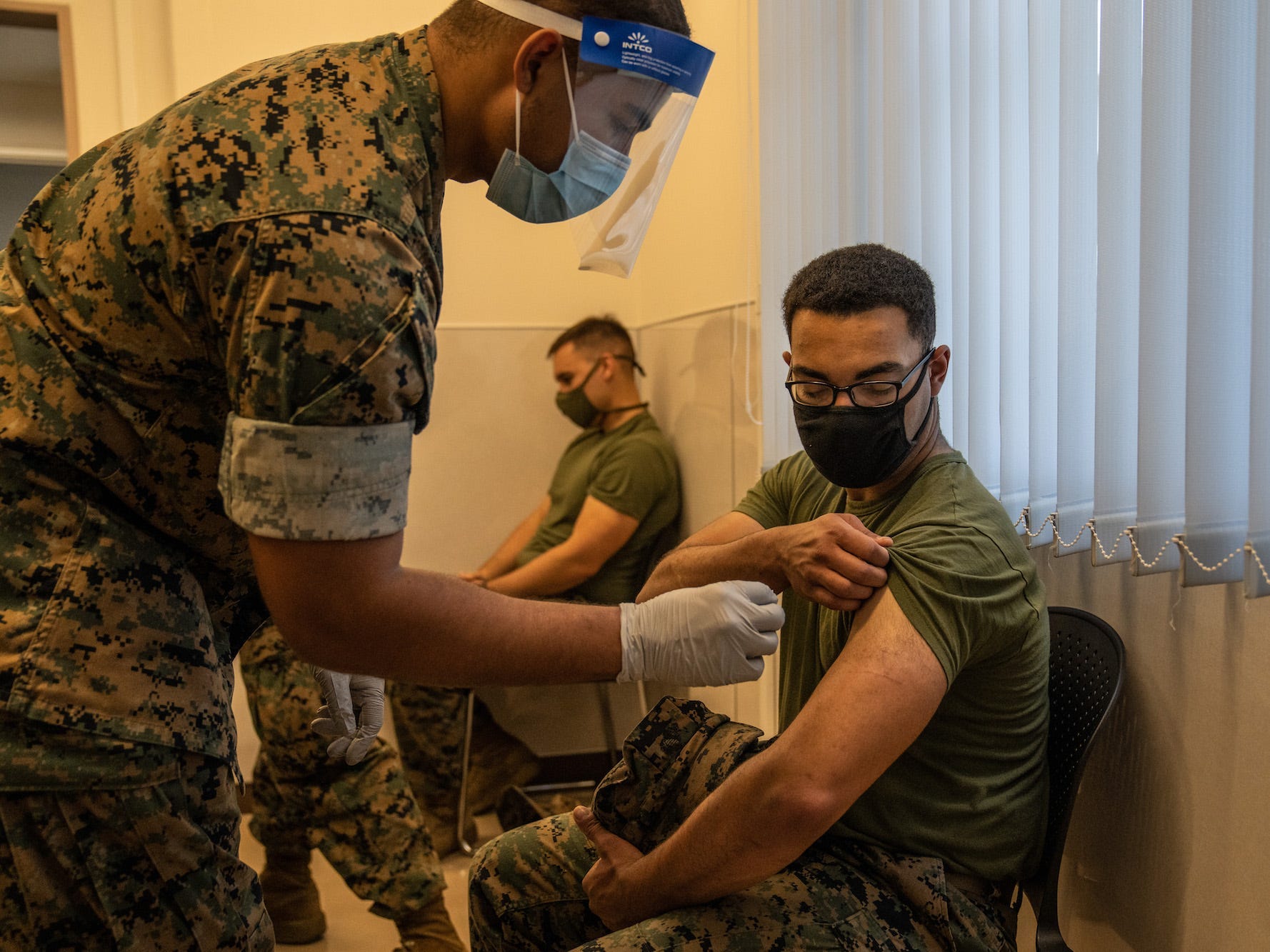 Members of the US Marine Corps receive vaccinations.