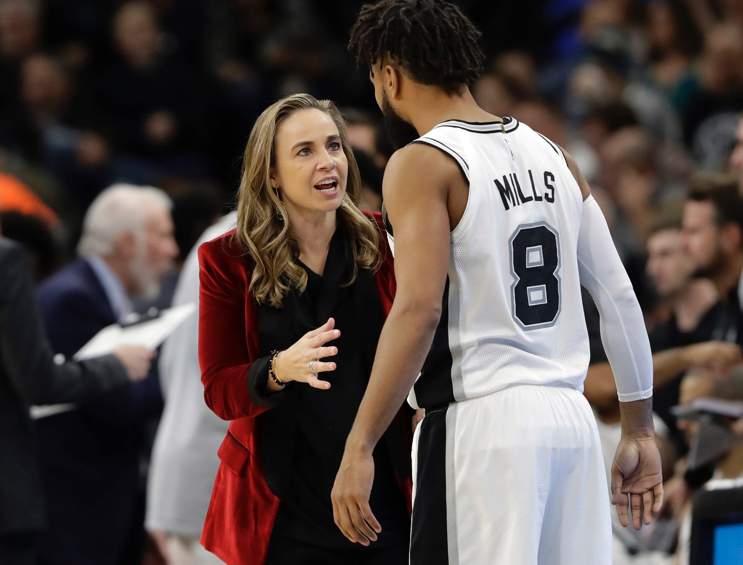 San Antonio Spurs assistant coach Becky Hammon speaks with Patty Mills.