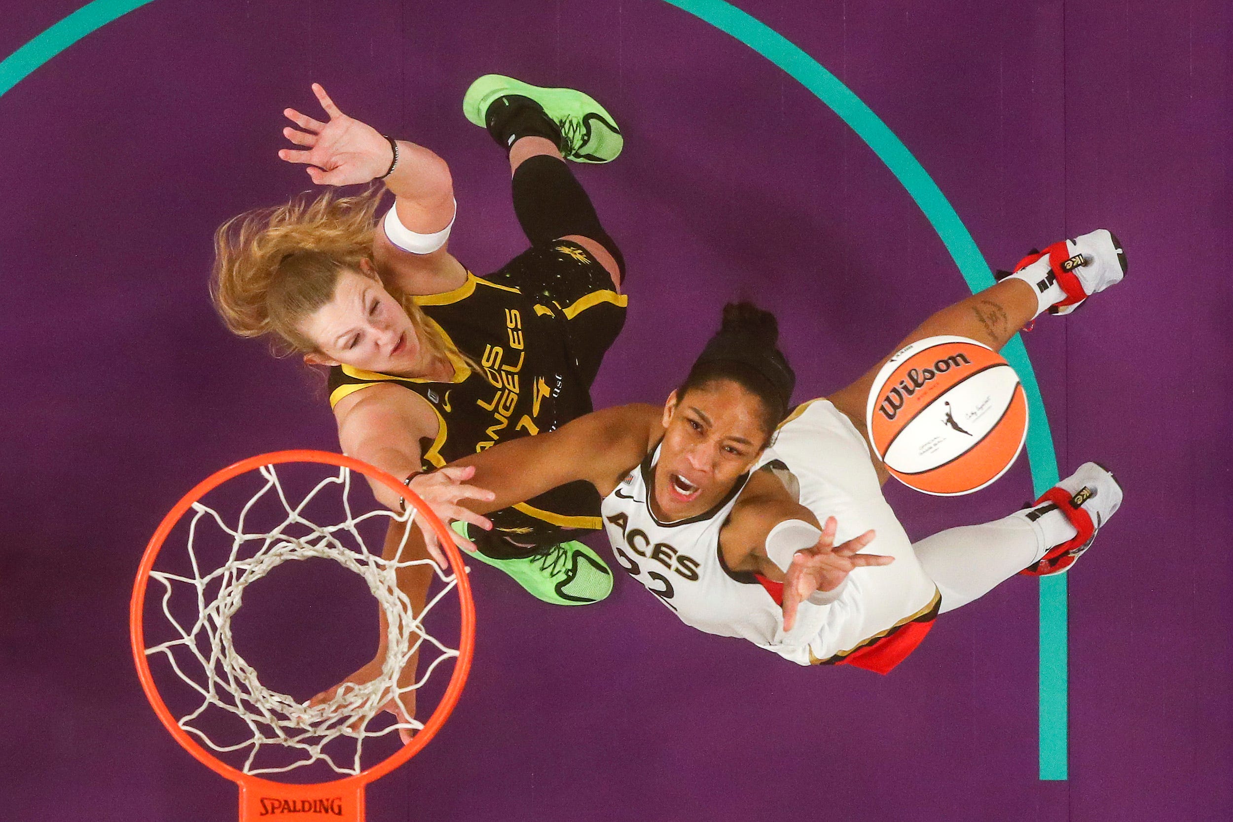 A'ja Wilson drives on Lauren Cox during a WNBA game.