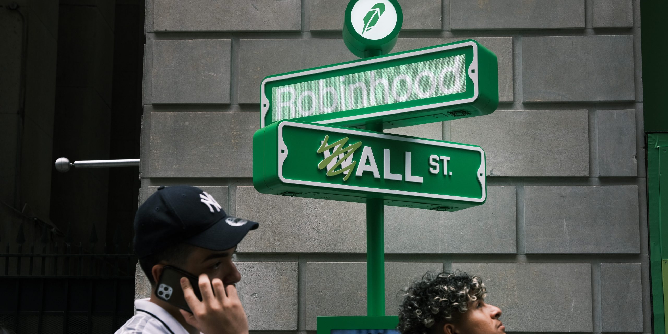 People wait in line for t-shirts at a pop-up kiosk for the online brokerage Robinhood along Wall Street after the company went public with an IPO earlier in the day on July 29, 2021 in New York City.