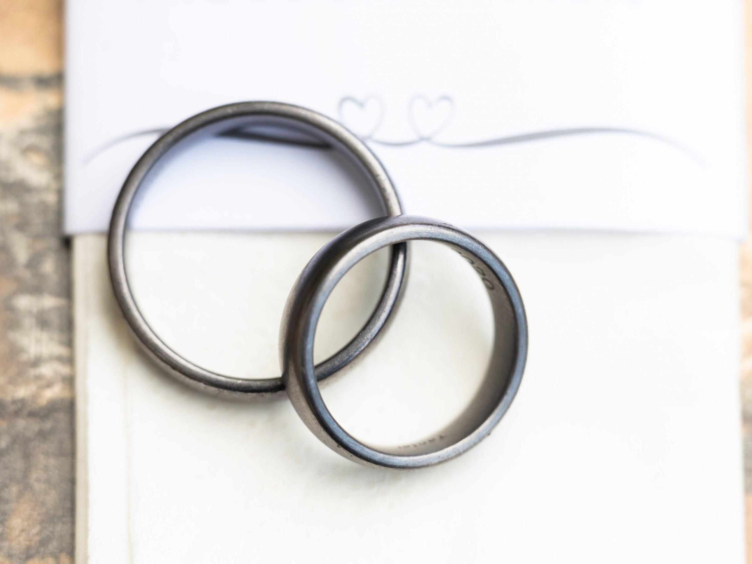 Two wedding rings are seen during a wedding ceremony.