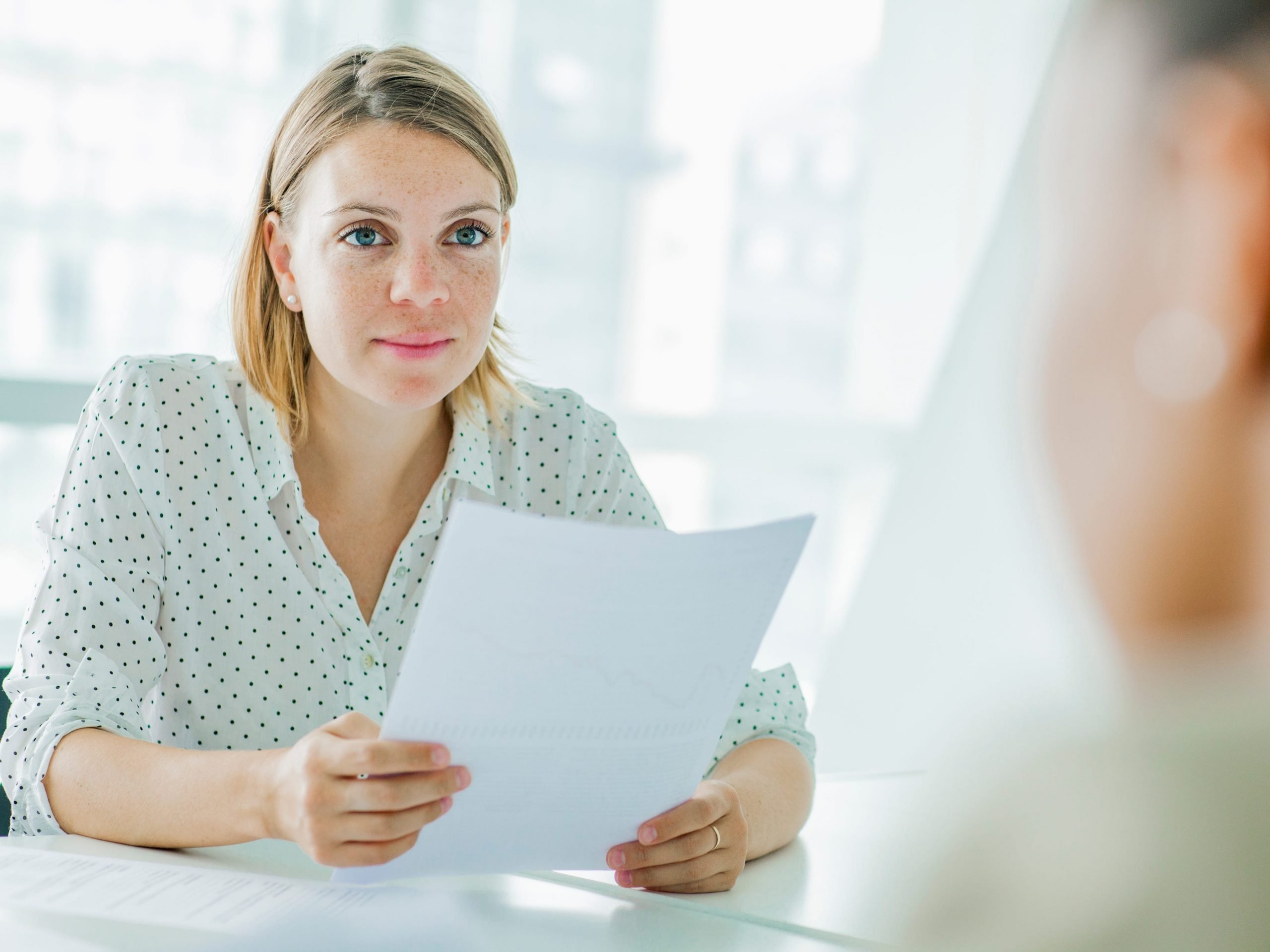 Woman holding a resume in hand