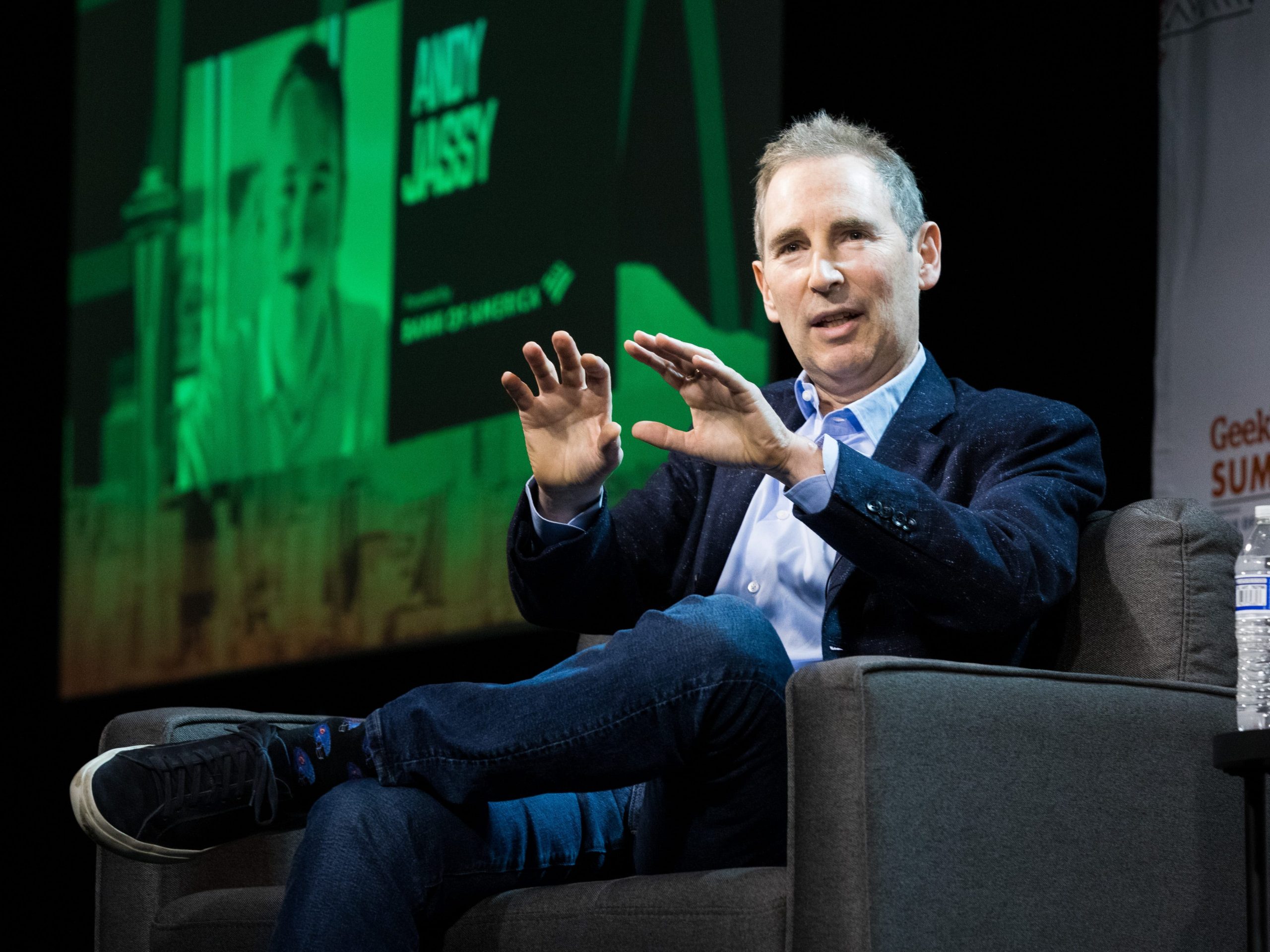 Amazon CEO Andy Jassy motions with his hands on stage at the GeekWire Summit.