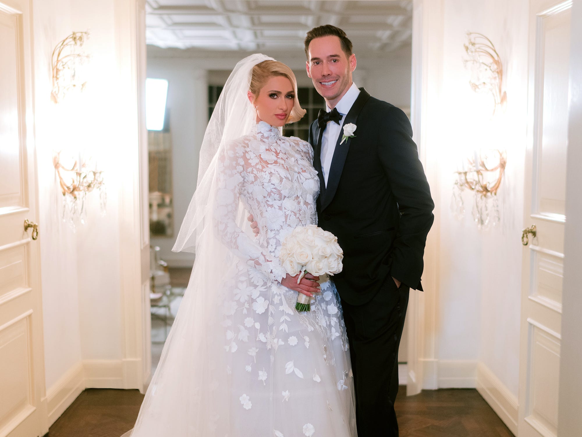 Paris Hilton and Carter Reum pose in their wedding attire.