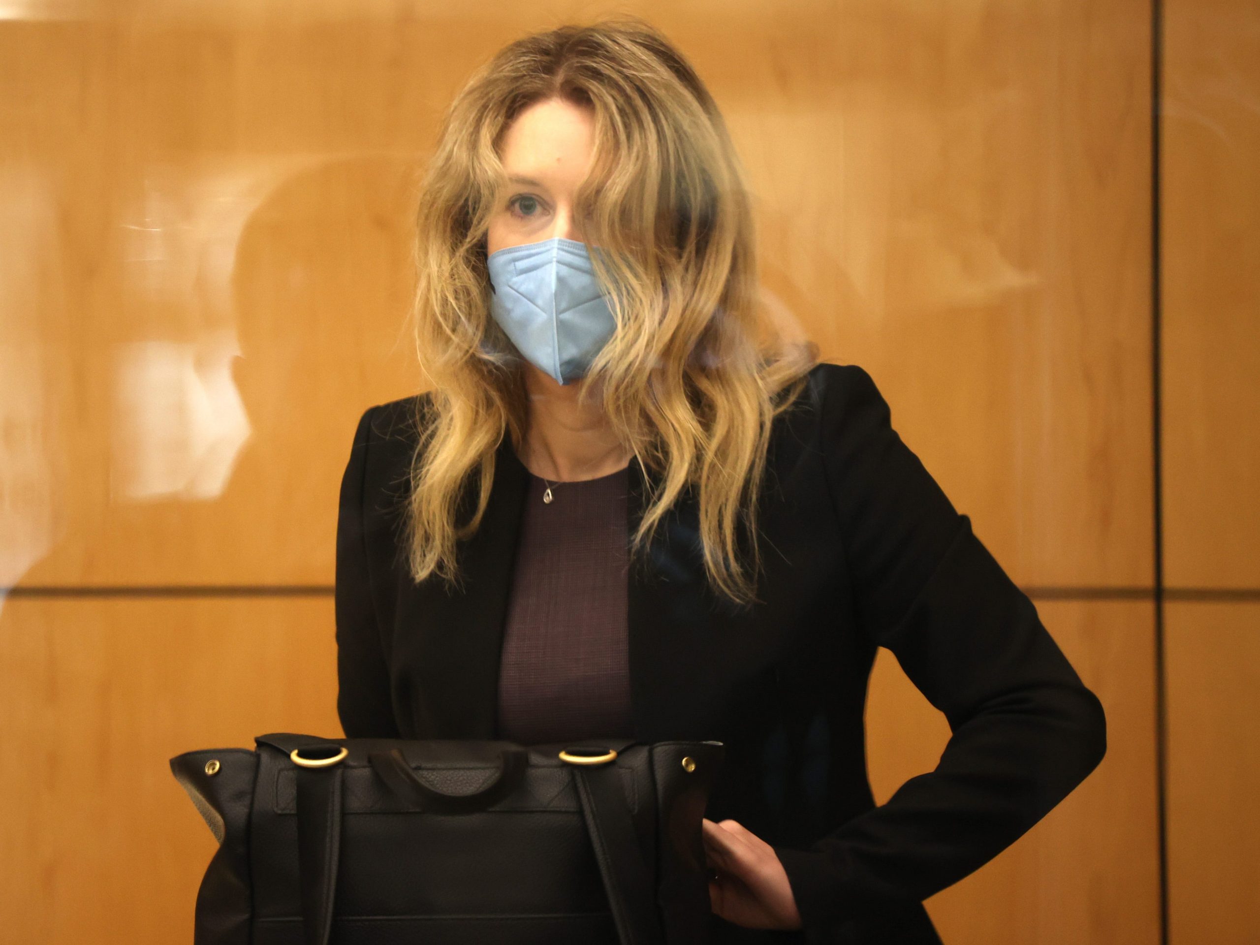 Theranos founder Elizabeth Holmes in a black suit jacket in a San Jose courtroom