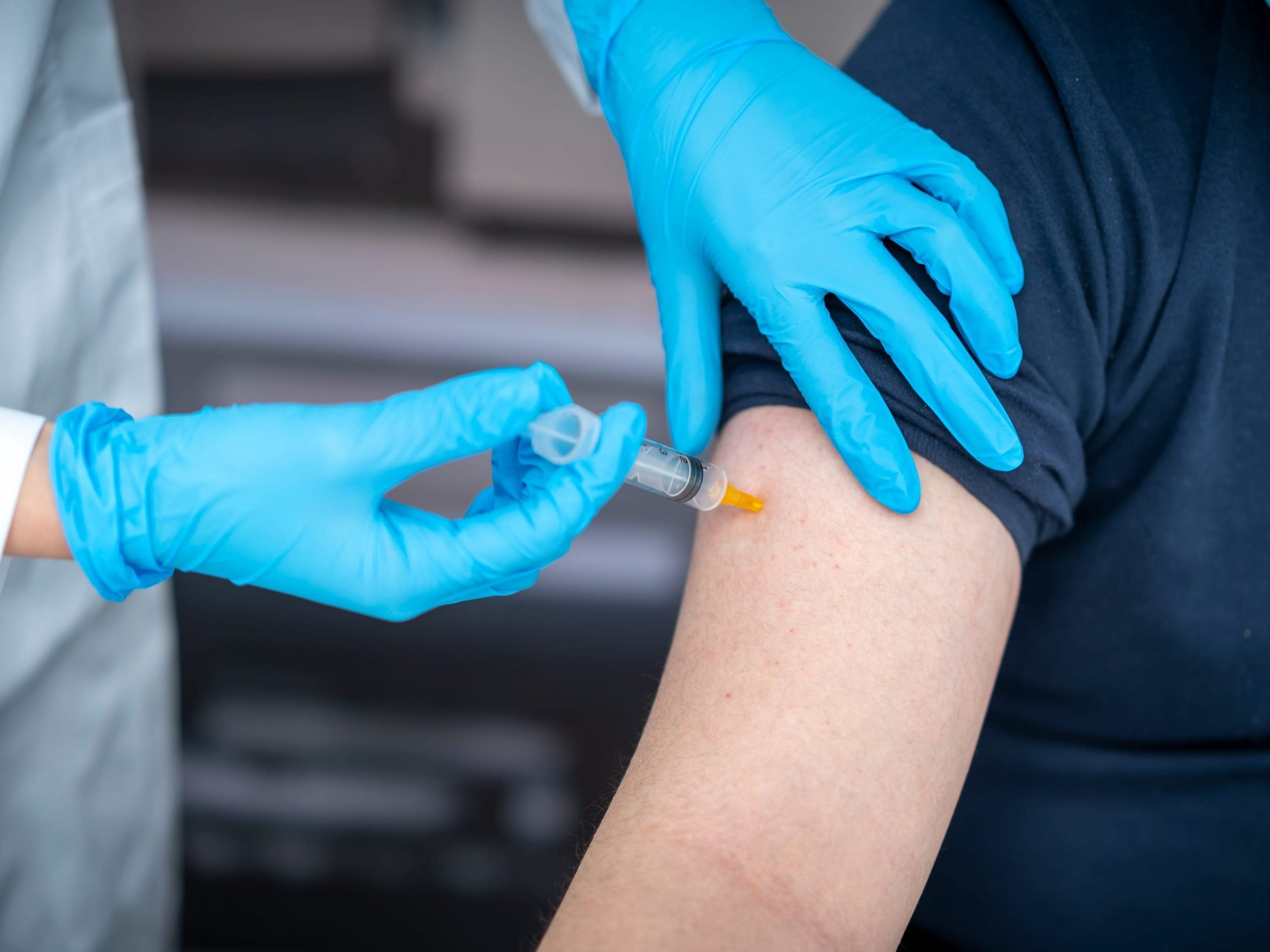 Man receives vaccine in arm