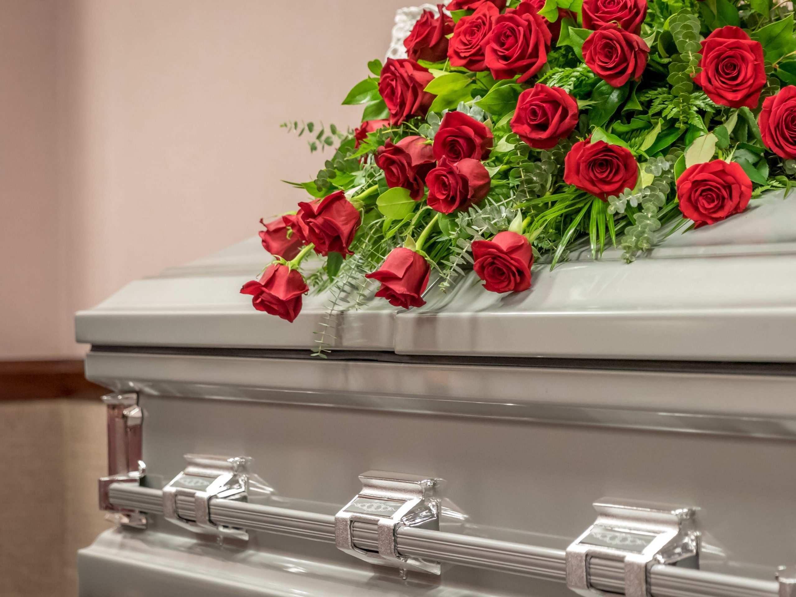 roses on a casket at a funeral