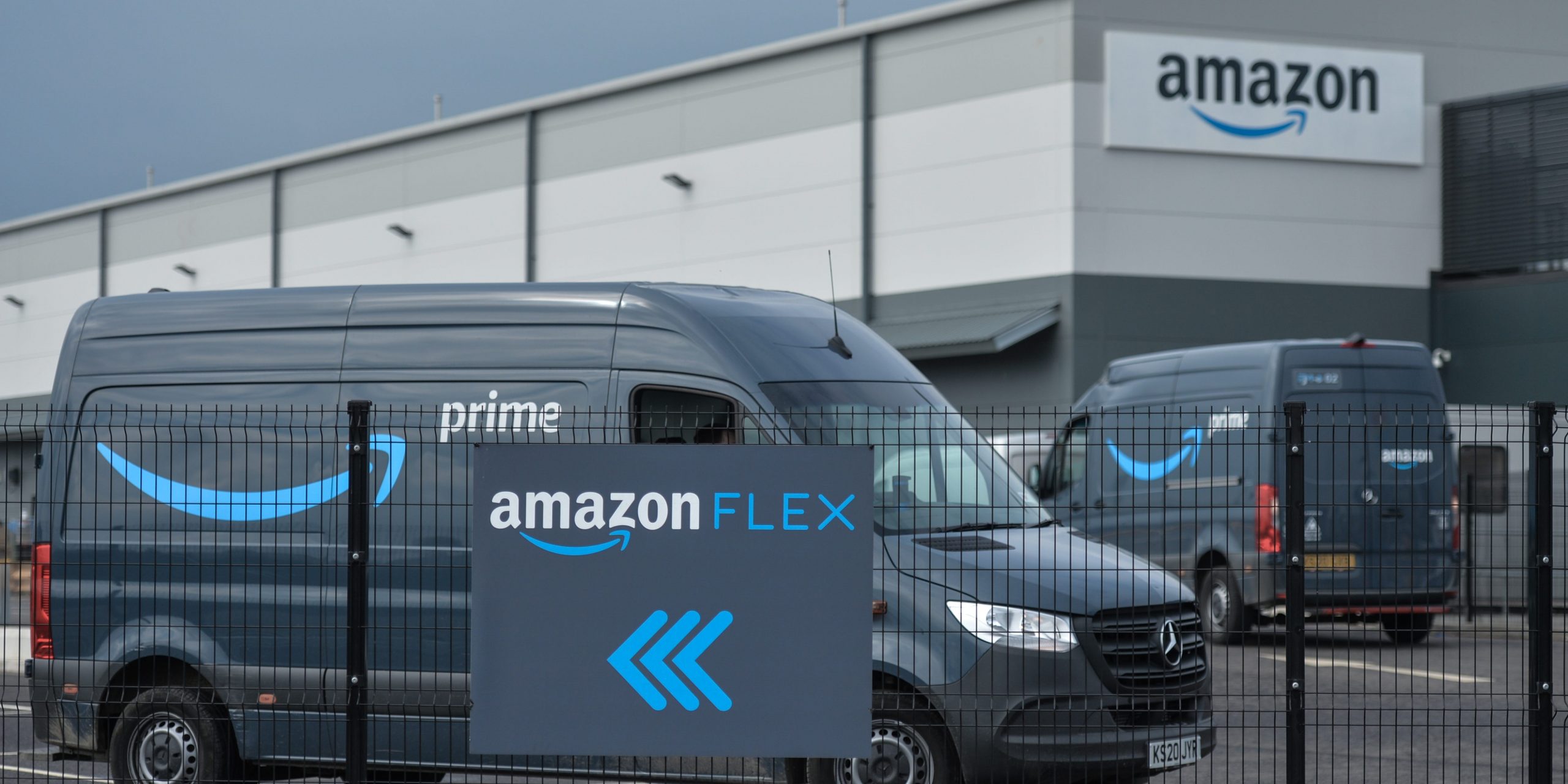 An Amazon Flex sign is shown with vehicles behind.