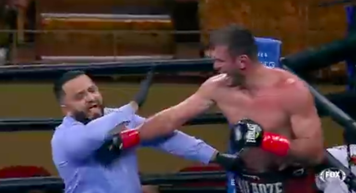 Iago Kiladze punches the referee during a fight.