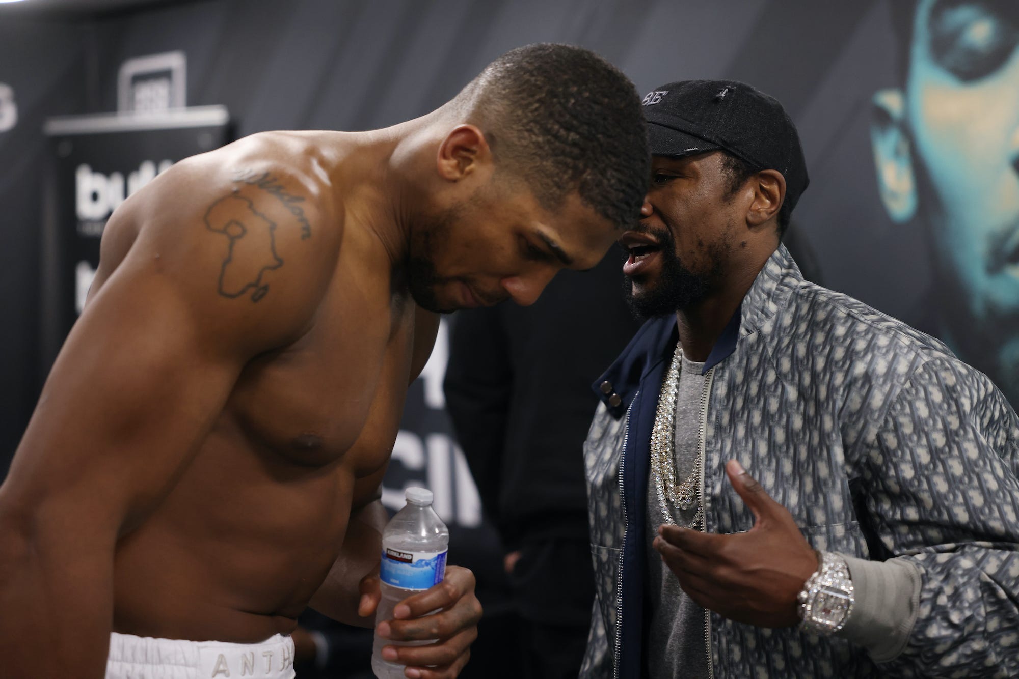 Anthony Joshua listens to Floyd Mayweather.