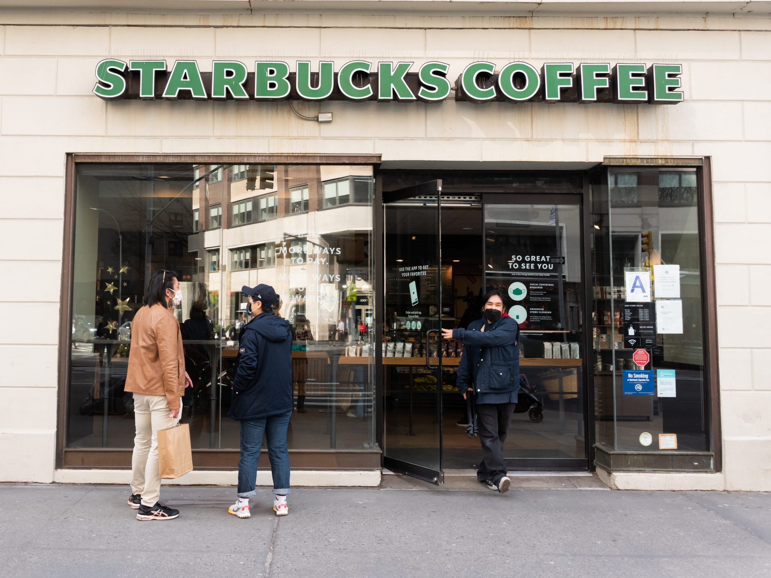 People stand outside Starbucks on the Upper West Side amid the coronavirus pandemic on March 23, 2021 in New York City.