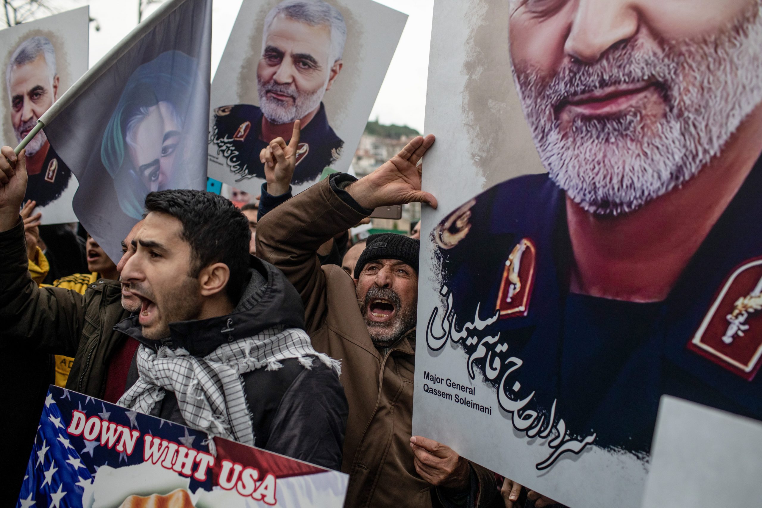 Protestors outside the US consulate in Istanbul hold portraits of Qassem Soleimani on January 3