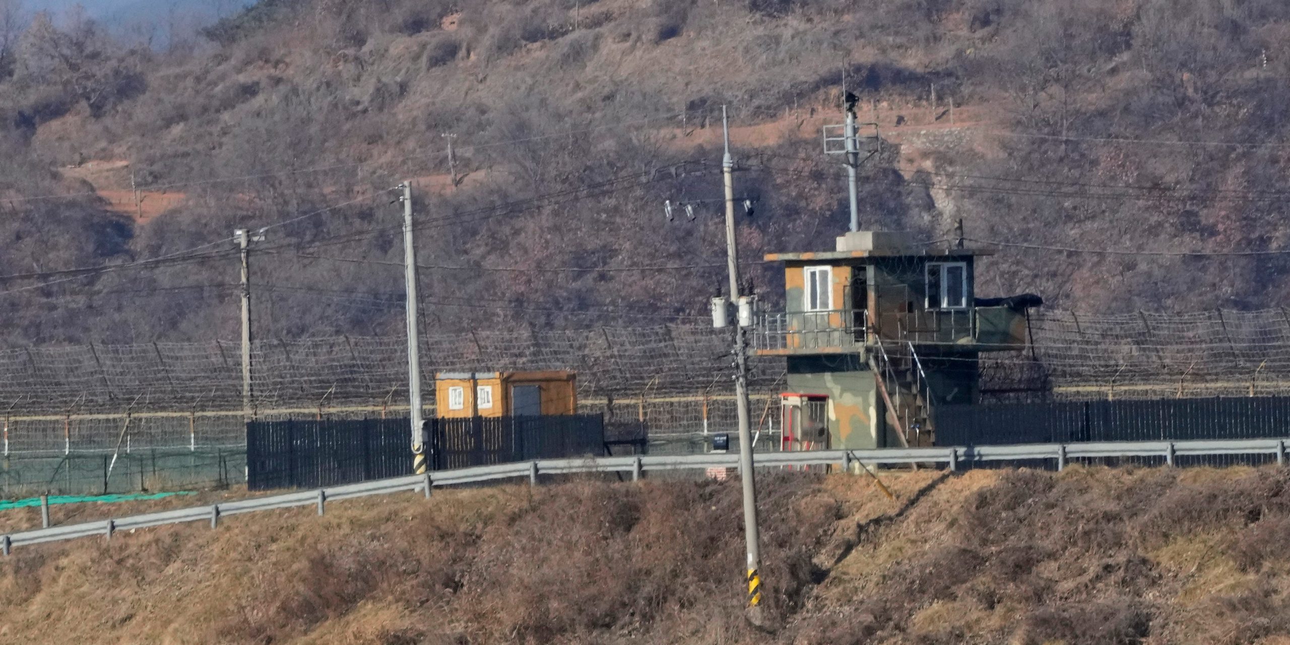 Military guard posts of North Korea, rear, and South Korea, front, are seen in Paju, near the border with North Korea, South Korea, Sunday, Jan. 2, 2022.