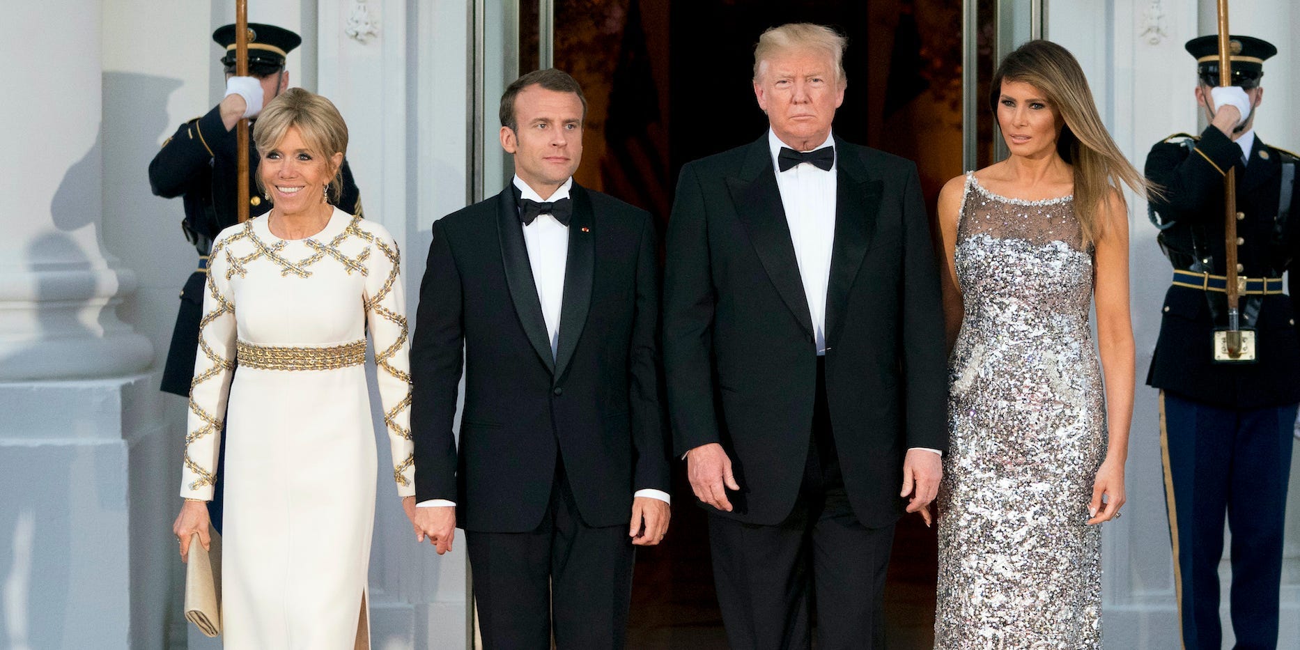 In this April 24, 2018, file photo, President Donald Trump, first lady Melania Trump, French President Emmanuel Macron and his wife Brigitte Macron, pose for photographs as they arrive for a State Dinner at the White House in Washington.