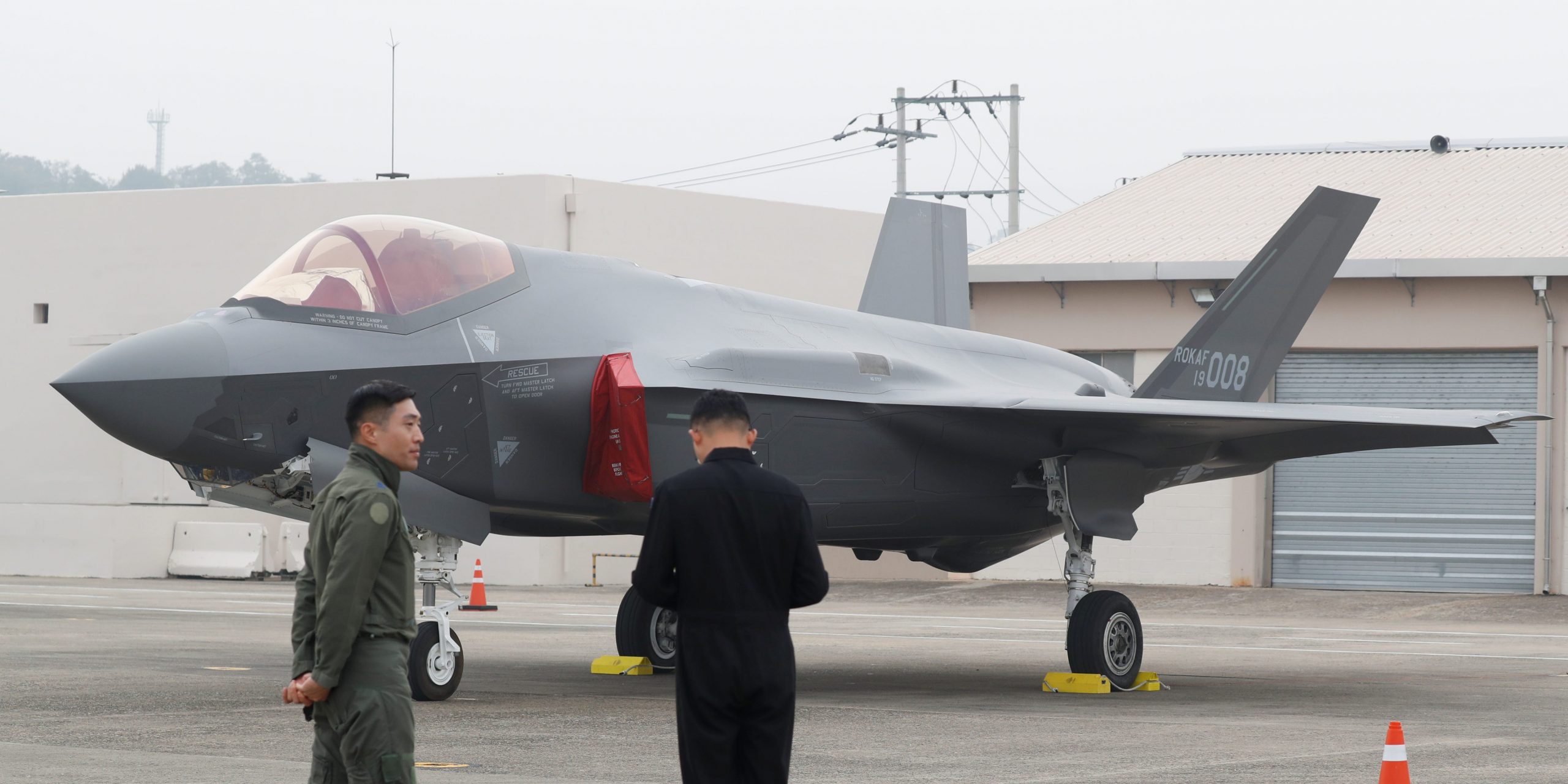 A South Korean fighter pilot (L) stands next to his F-35 stealth fighter during a ceremony to mark the 71st Armed Forces Day at the Air Force Base in Daegu, South Korea, October 1, 2019