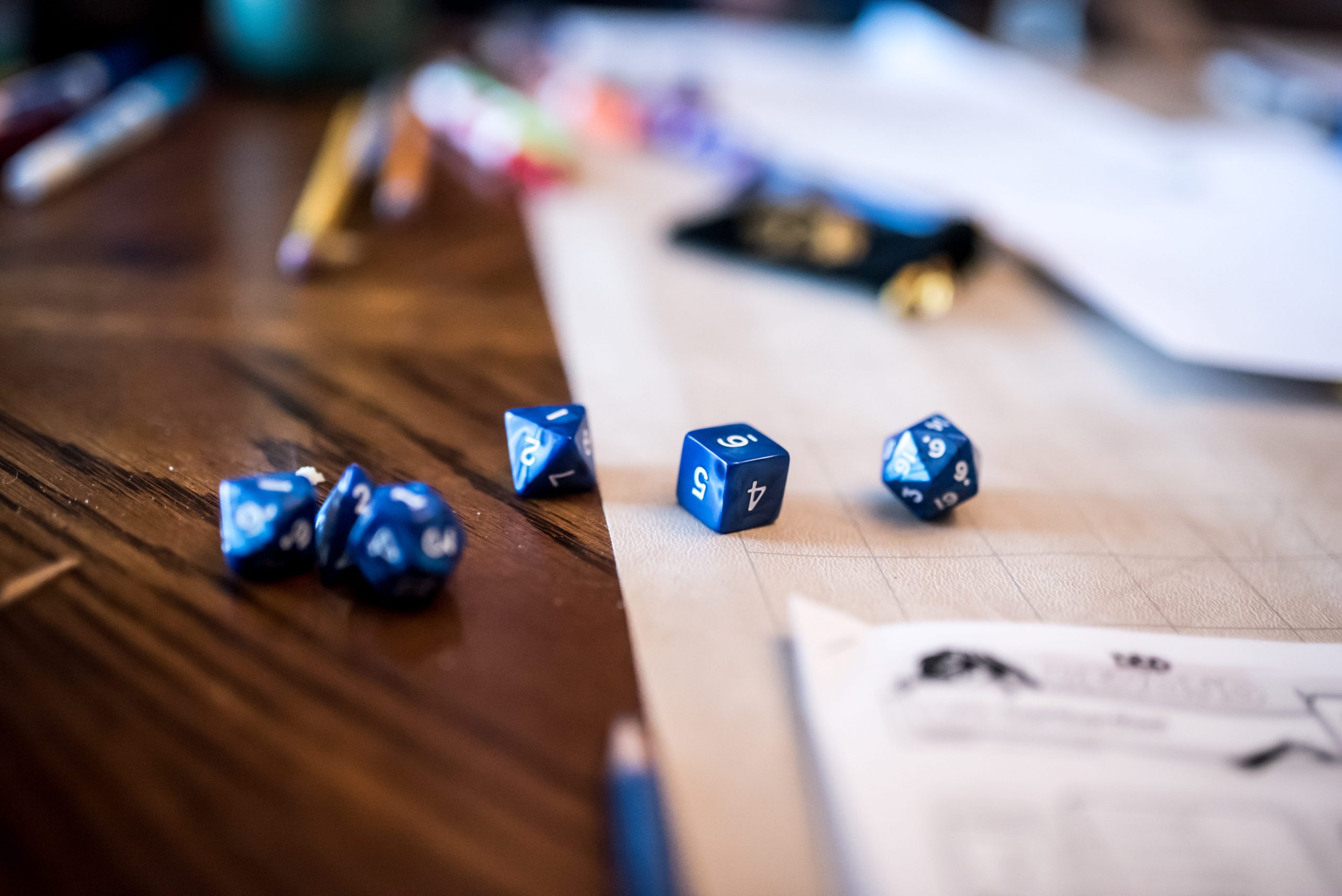 A Dungeons & Dragons game with dice and pencils.