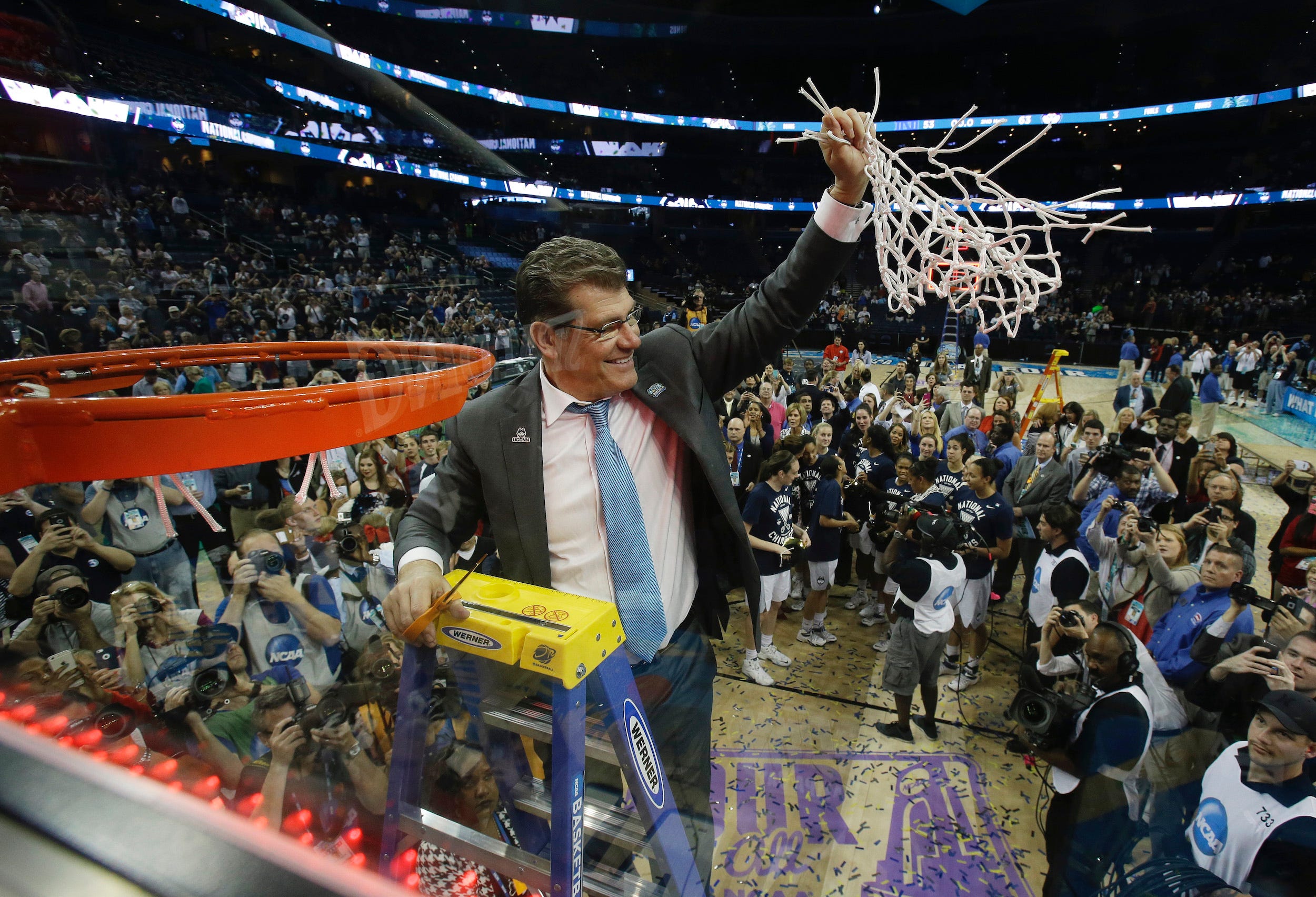 Geno Auriemma cuts down the net after UConn defeated Notre Dame in the 2015 National Championship game.