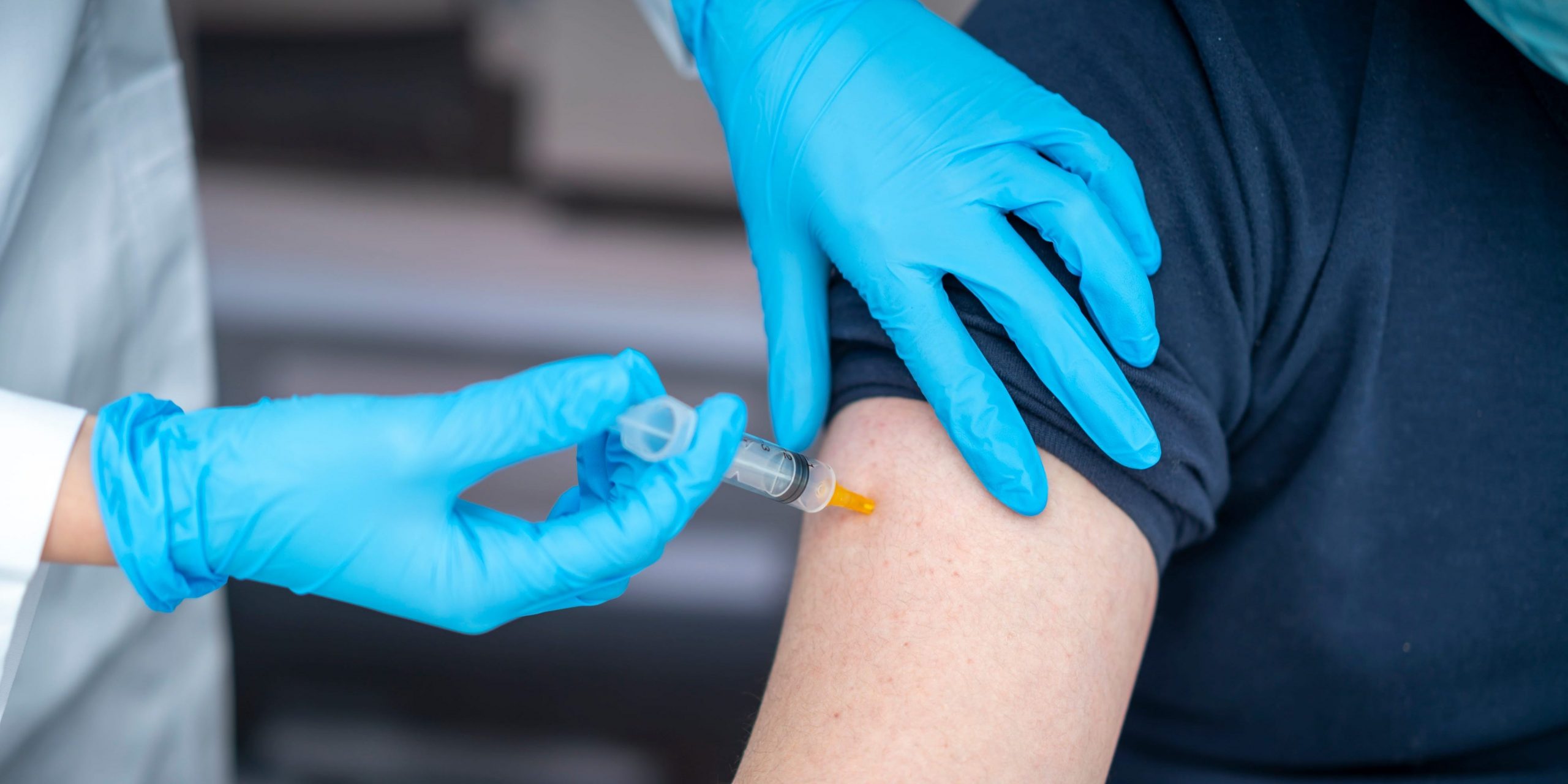 Man receives vaccine in arm