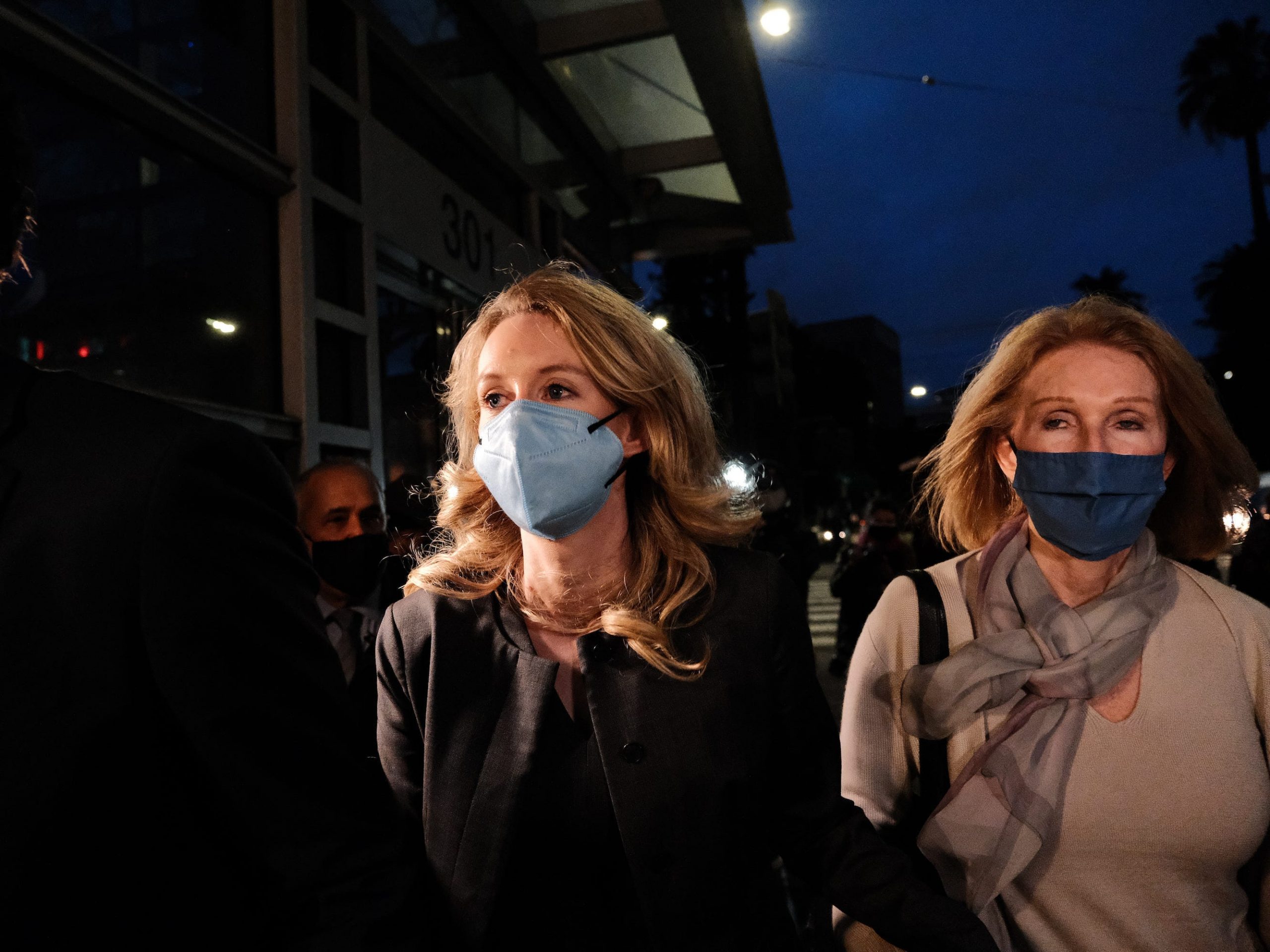 Theranos founder and former CEO Elizabeth Holmes (C) and her mother Noel Holmes leave the Robert F. Peckham Federal Building on January 3, 2022 in San Jose, California.